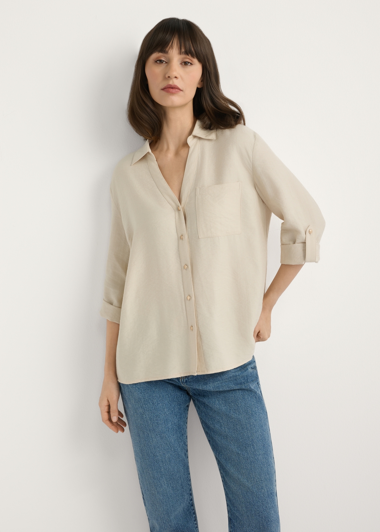 Light beige women's shirt KOSDT-0157A-1A(W26), front view of the product on the model. Half of the silhouette visible.