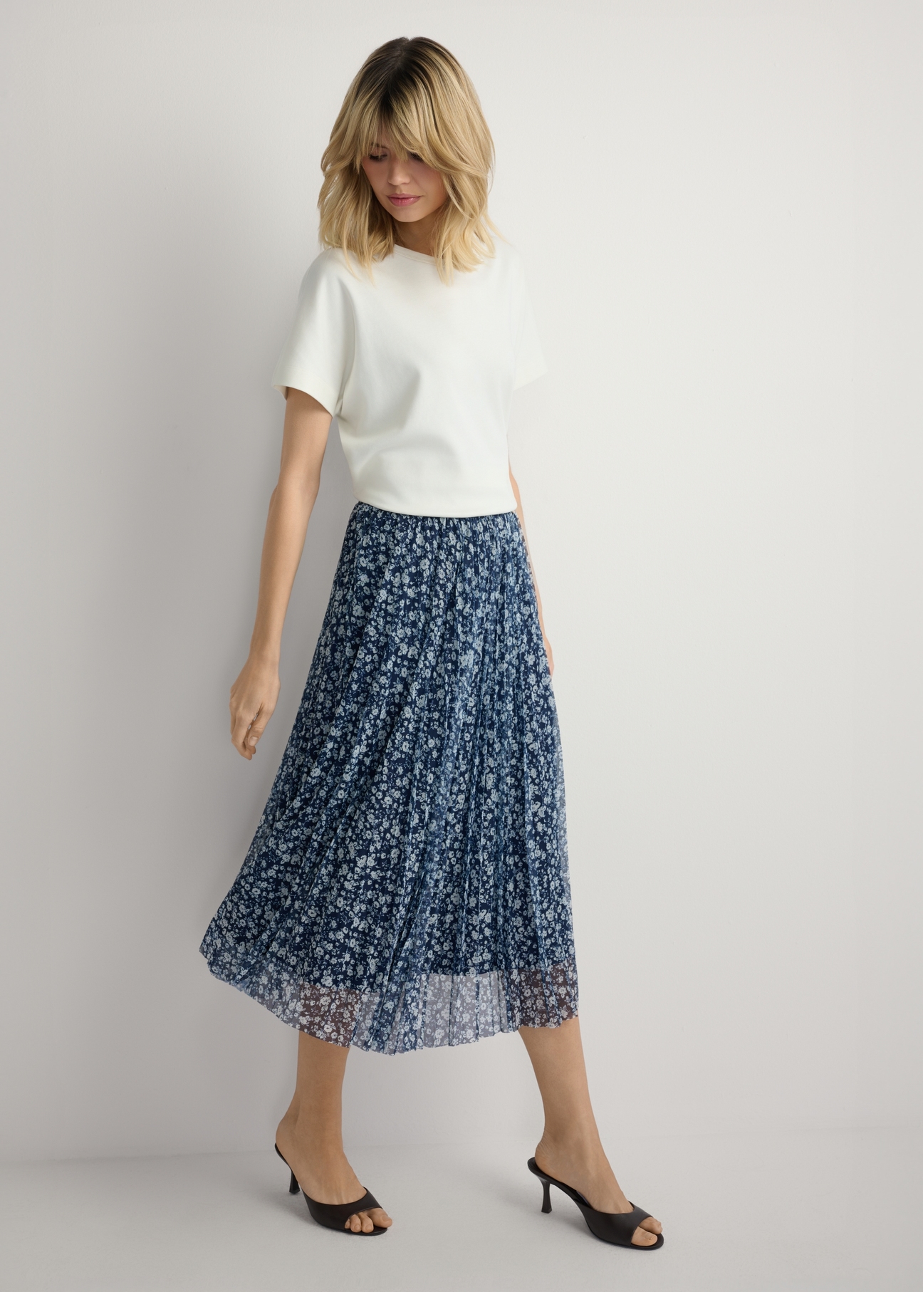Floral Pleated Midi Skirt SPCDT-0110-7P(W26), front view of the product on the model. Full silhouette visible.
