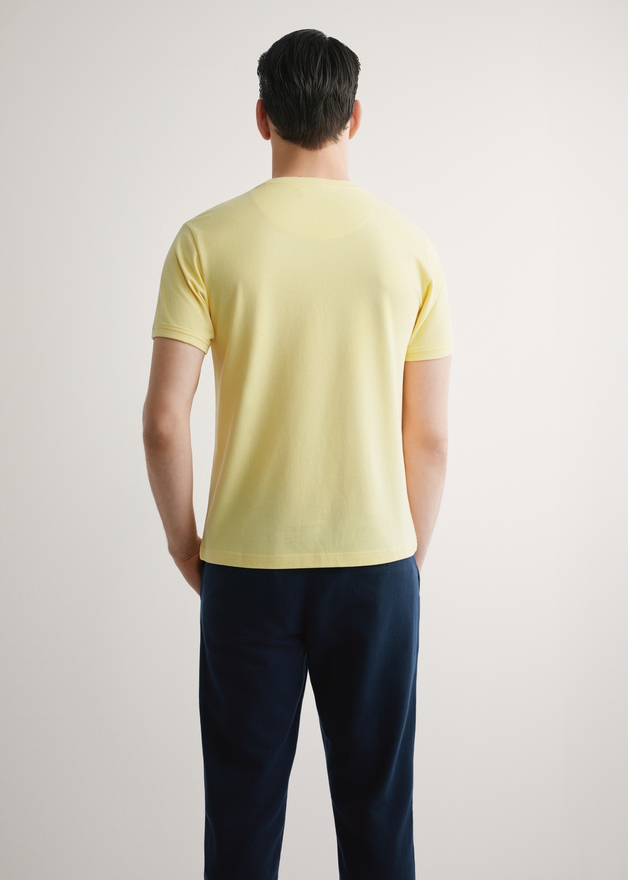 Men's yellow cotton t-shirt TSHMT-0136-2B(W26), back view of the product on the model. Half of the silhouette visible.