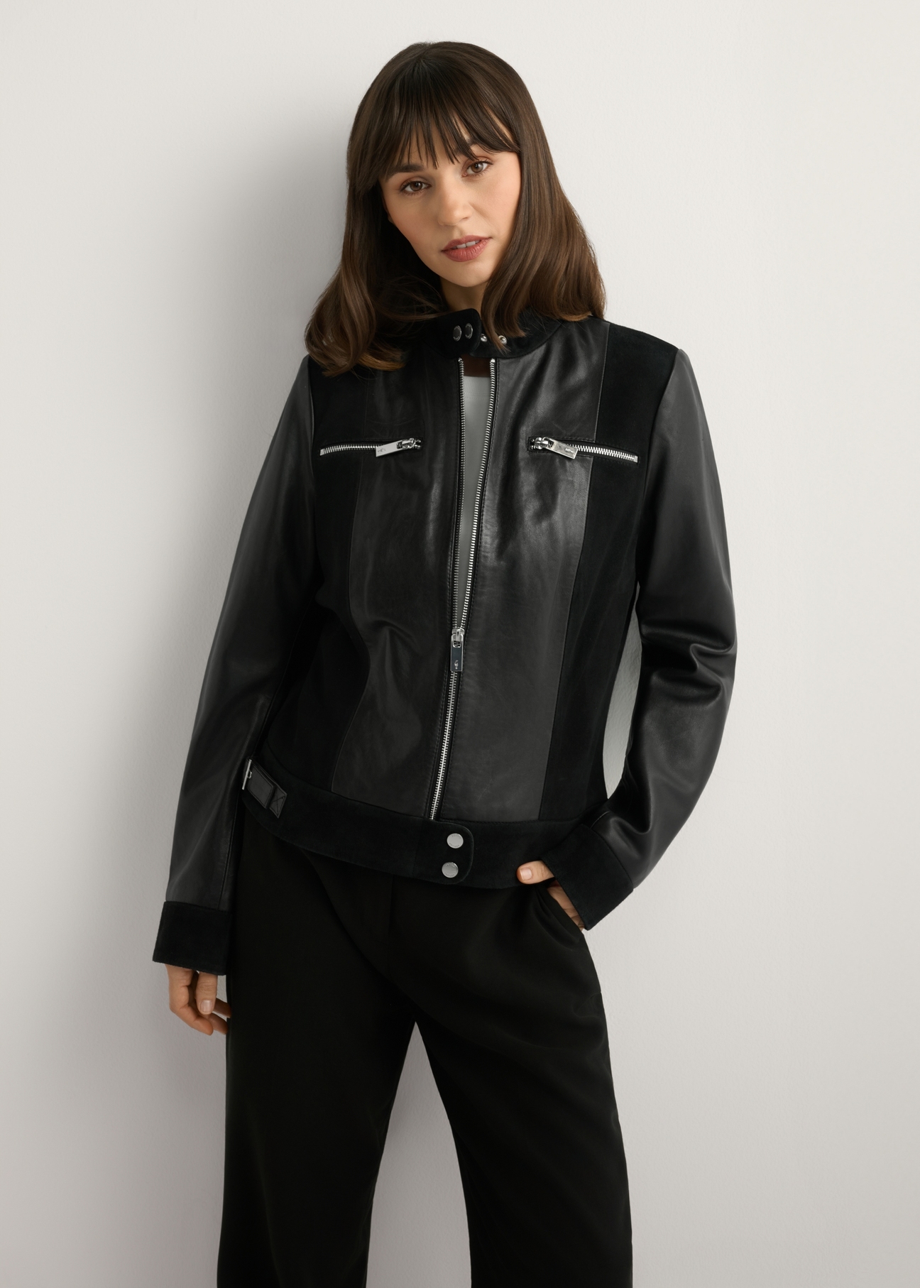 Women's black leather jacket KURDS-0587-99(W26), front view of the product on the model. Half of the silhouette visible.