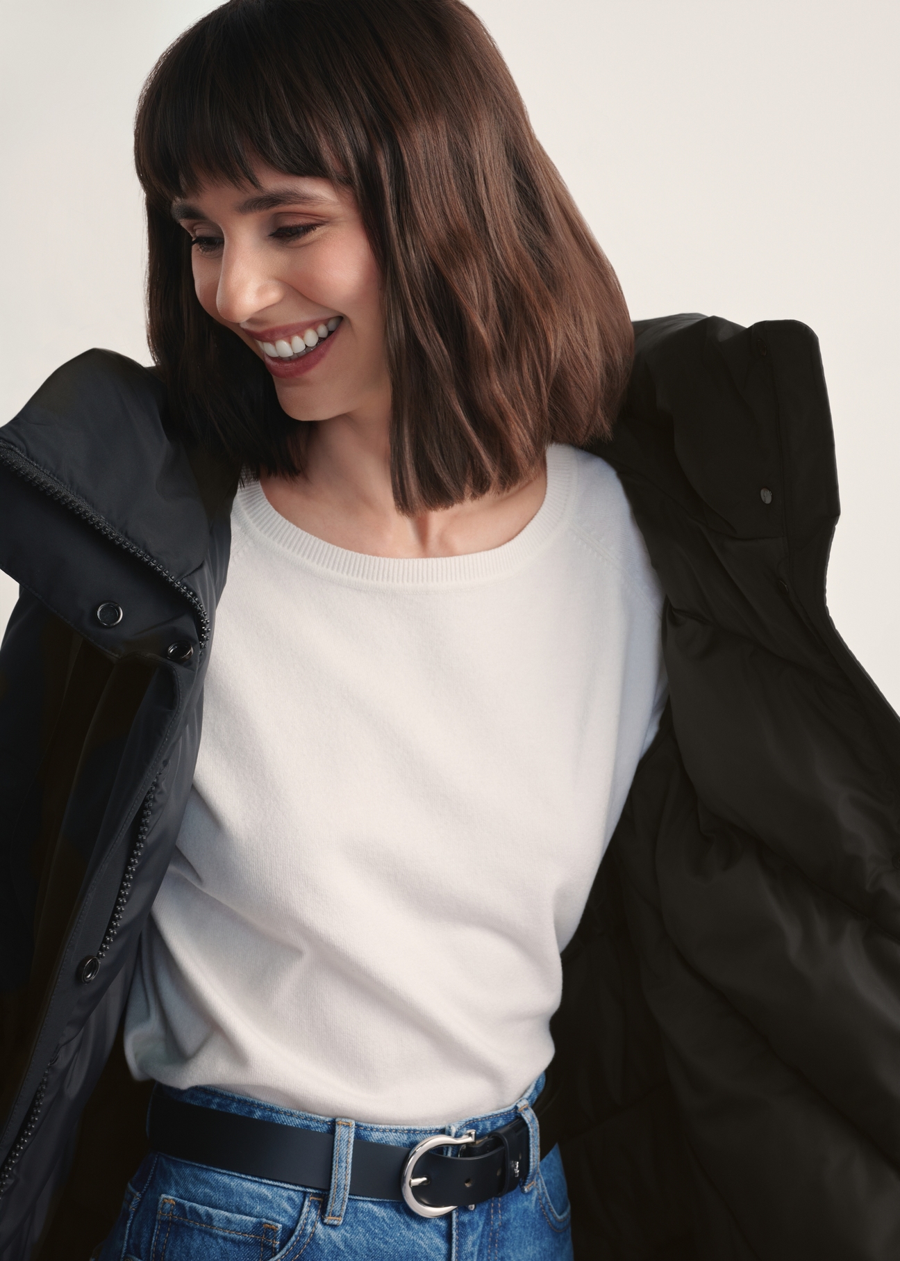 Black women's winter jacket KURDT-0583-99(Z25), front view of the product on a model. Half of the silhouette visible.