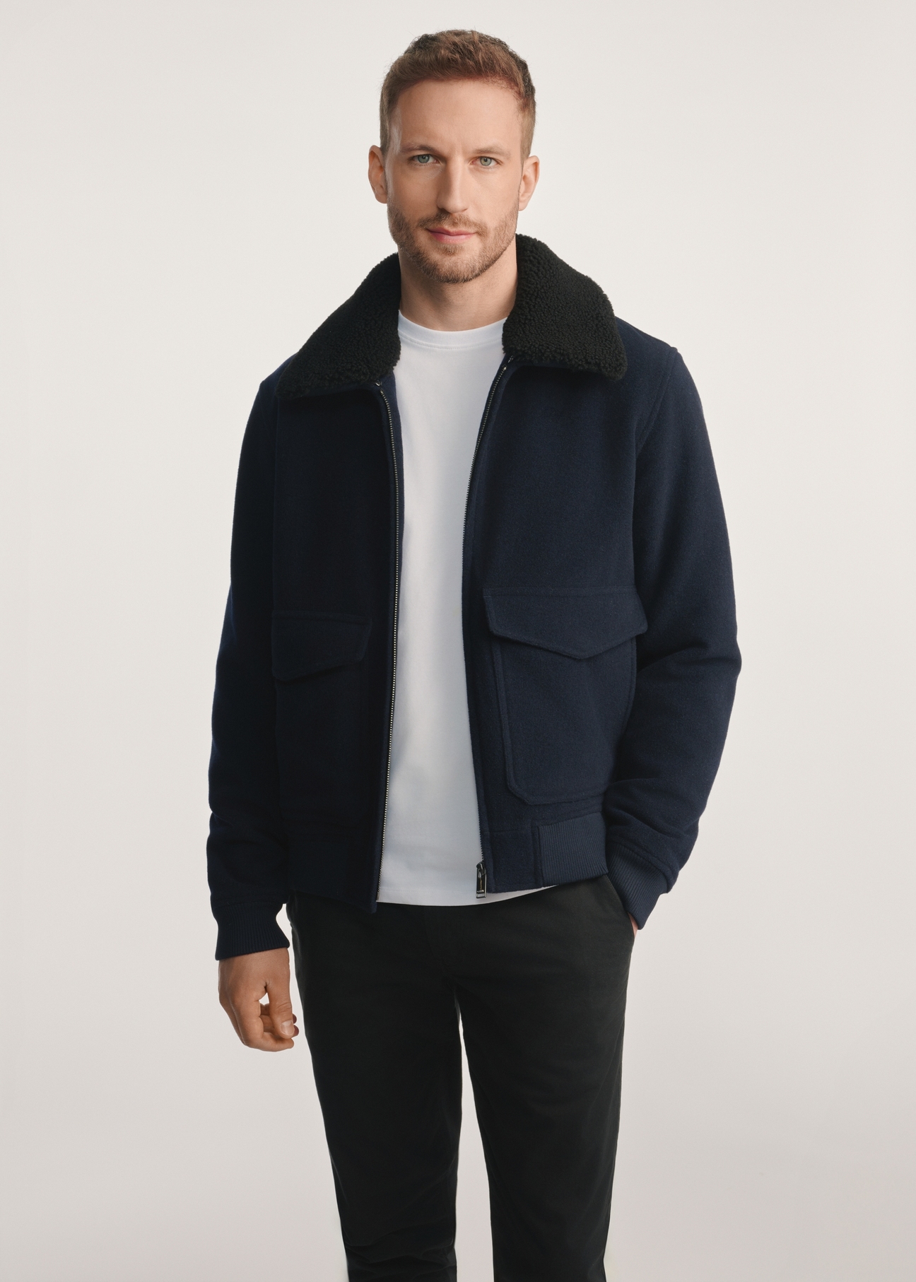 Navy blue men's sheepskin jacket PLAMT-0009-69(Z25), product visible from the front on the model, half of the silhouette visible.
