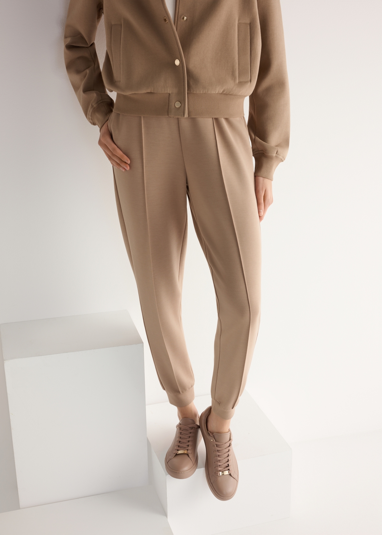 Women's pink leather sneakers BUTYD-1068-5D(W26), product view from the front on the model, half of the silhouette visible.