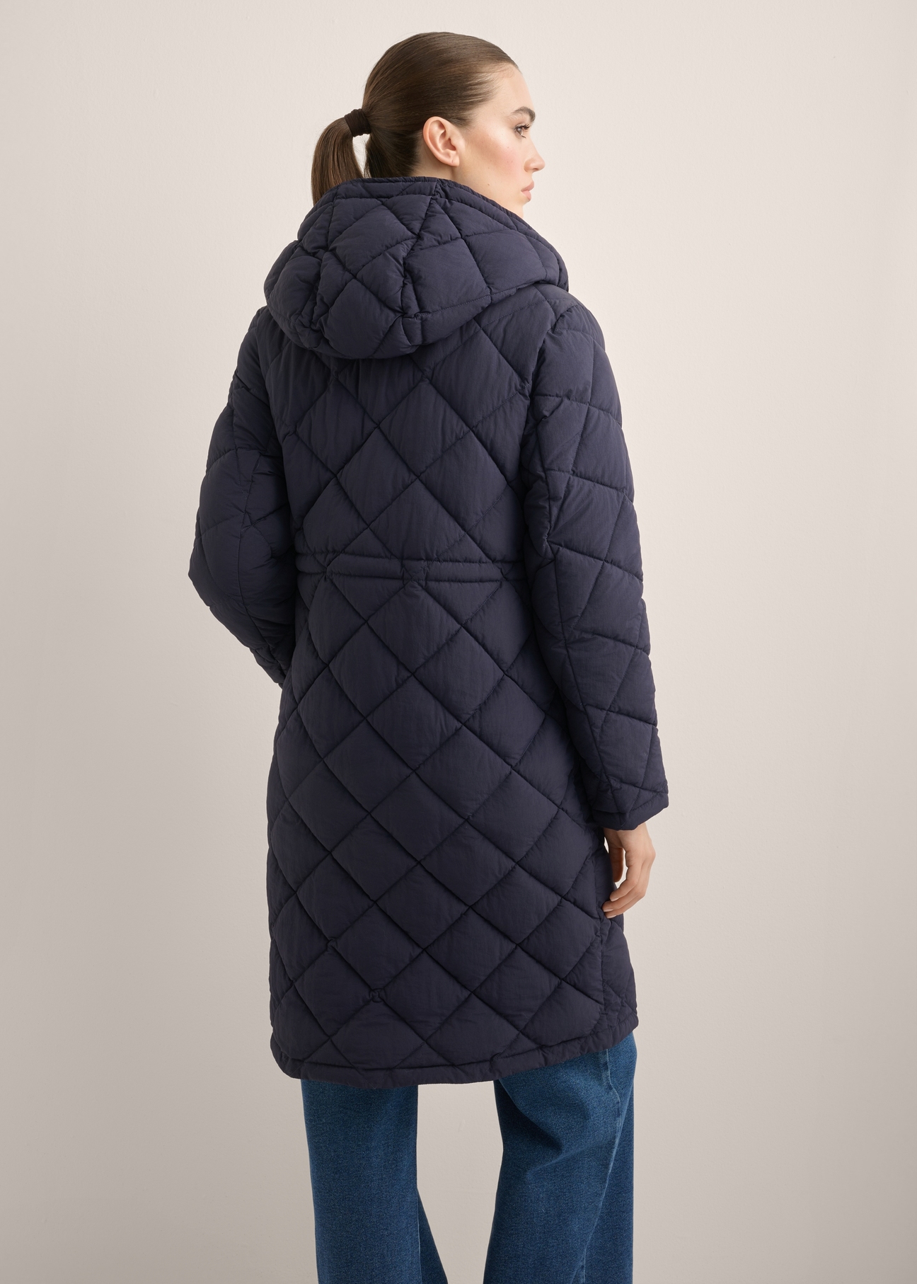 Navy blue women's quilted jacket KURDT-0667-7D(Z26), product view from the back on the model. Half of the silhouette visible.