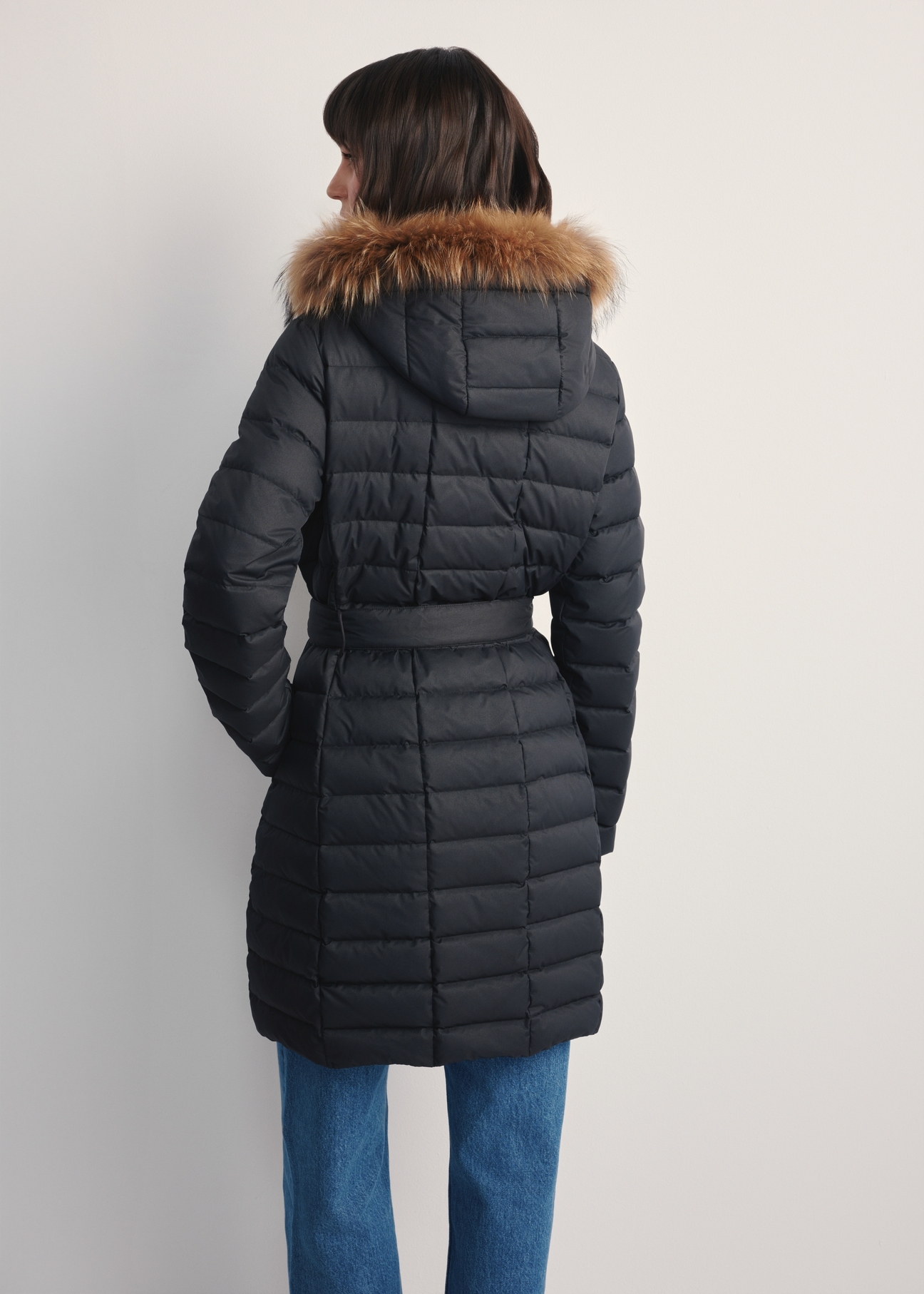 Women's black winter jacket KURDT-0617-99(Z25) - back view of the product on a model against a white background. Knee-length silhouette visible.