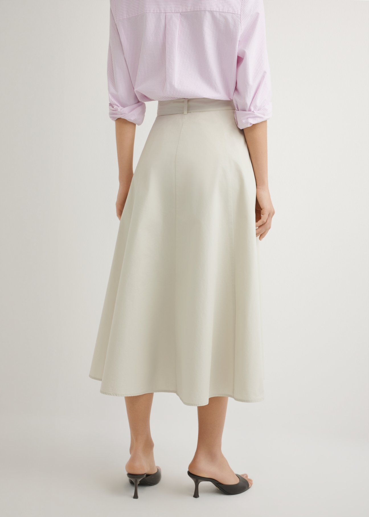 Beige midi skirt SPCDT-0123-1A(W26), back view of the product on the model. Half of the silhouette visible.