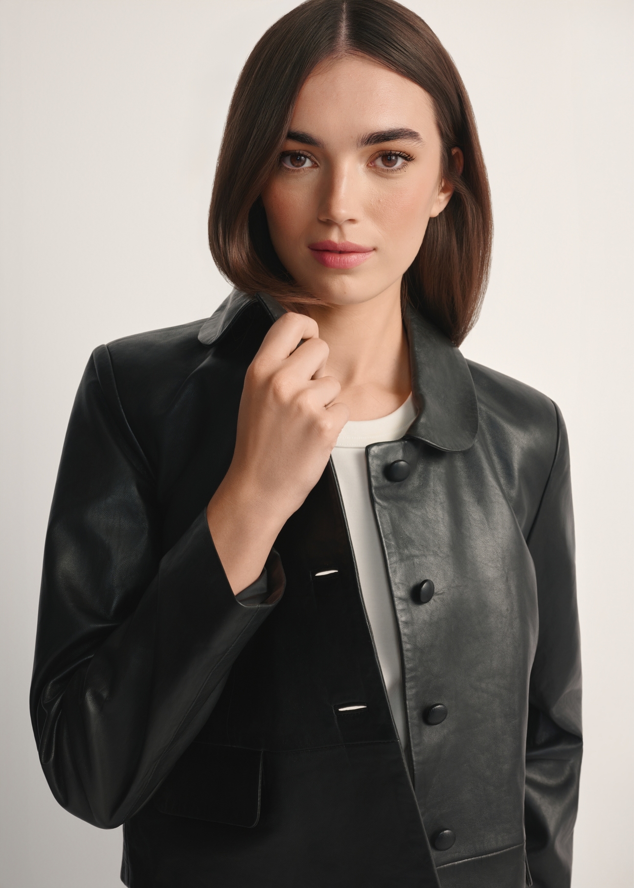 Black short women's leather jacket KURDS-0598-99(W26), front view of the product on the model, half of the silhouette visible.-02