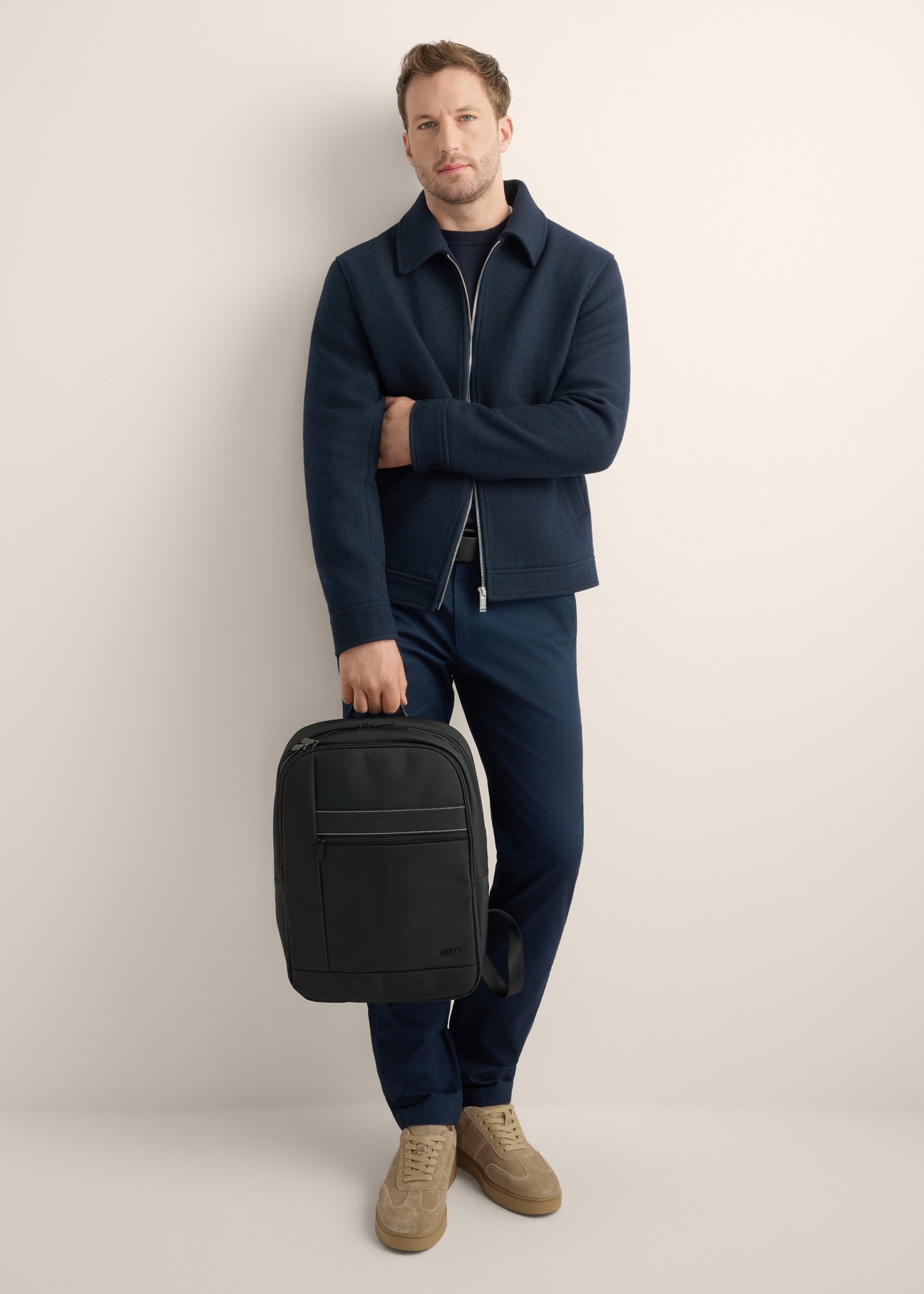 Black two-compartment men's backpack TORMN-0421-99(Z26), front view of the product on the model, the entire silhouette is visible.