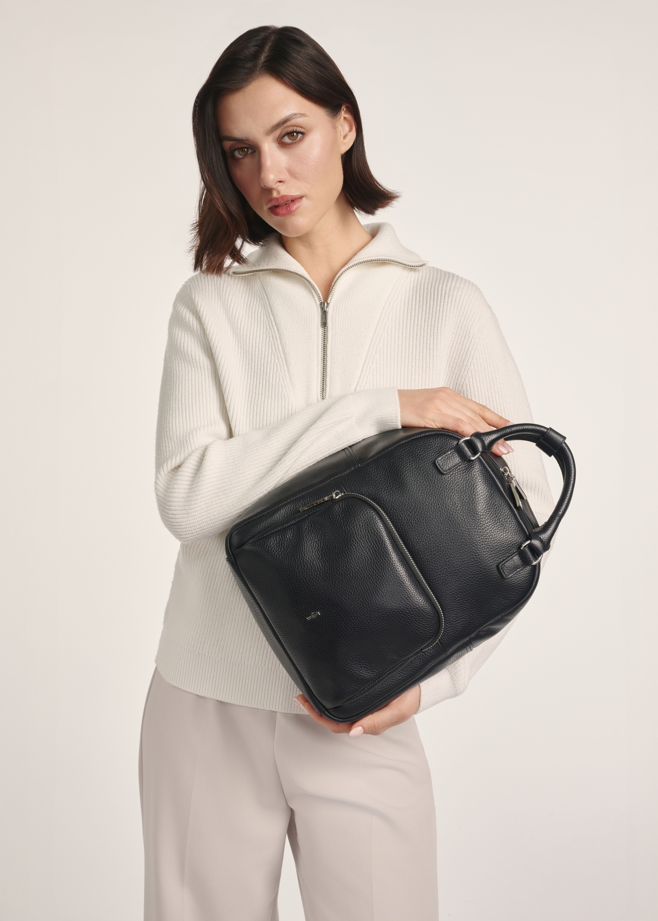 Women's leather backpack TORES-1146A-99(Z25), product visible from the front on the model, half of the silhouette visible.