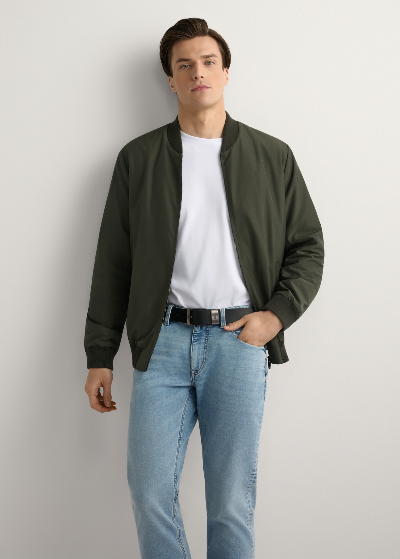Men's khaki bomber jacket KURMT-0413-8D(W26) - front product view, modeled, against a light background. Knee-length silhouette visible.