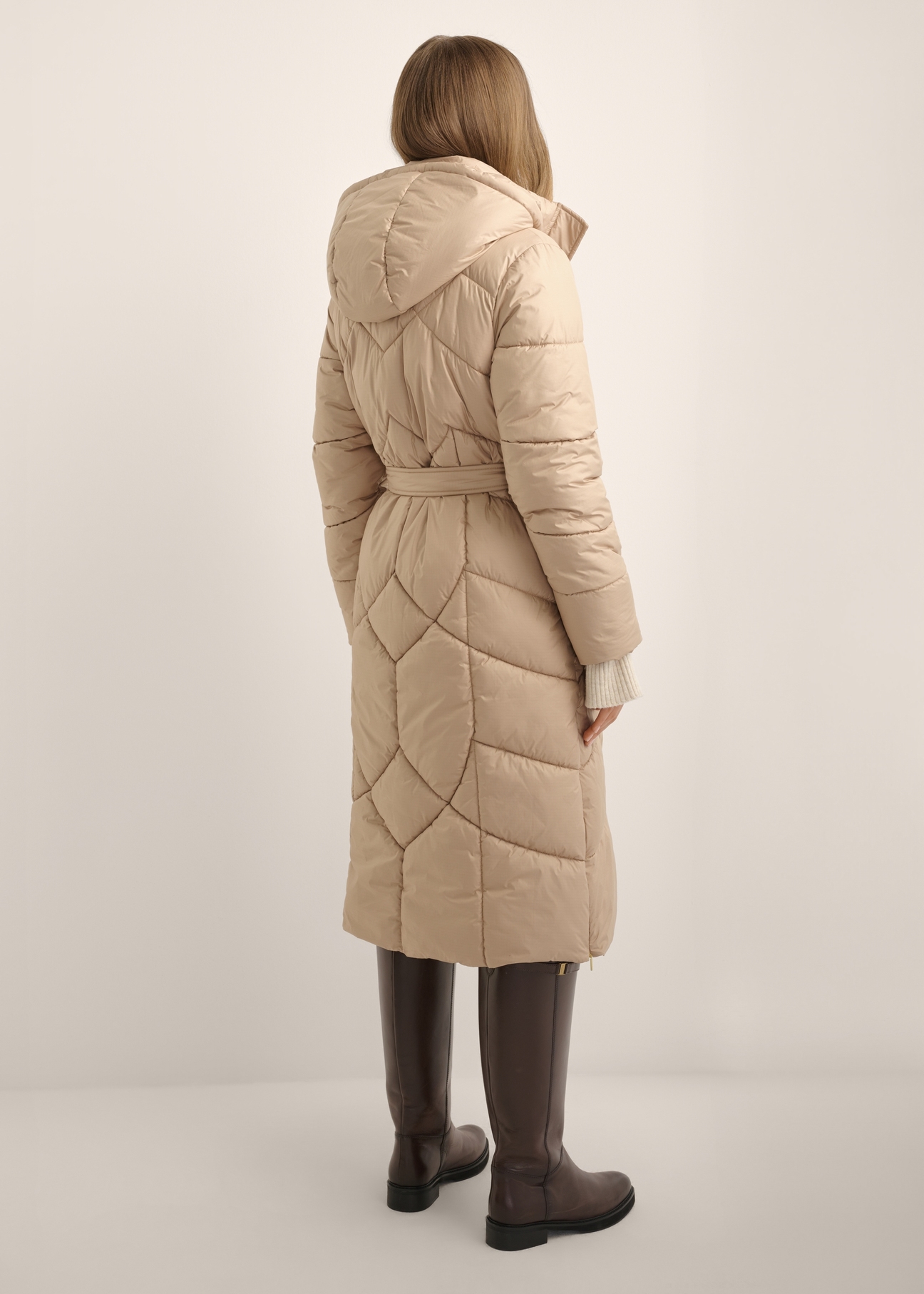 Long beige women's jacket KURDT-0701-1D(Z26), back view of the product on the model. Full body visible.