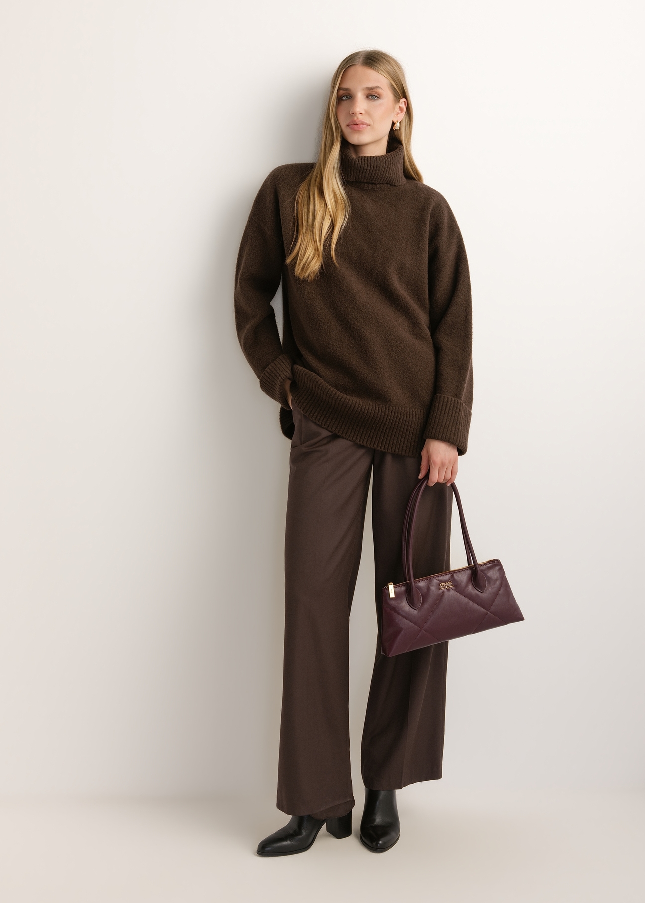 Burgundy, trapezoidal women's handbag with decorative stitching TORES-1363-4D(Z26), front view of the product on a model. Full body visible.
