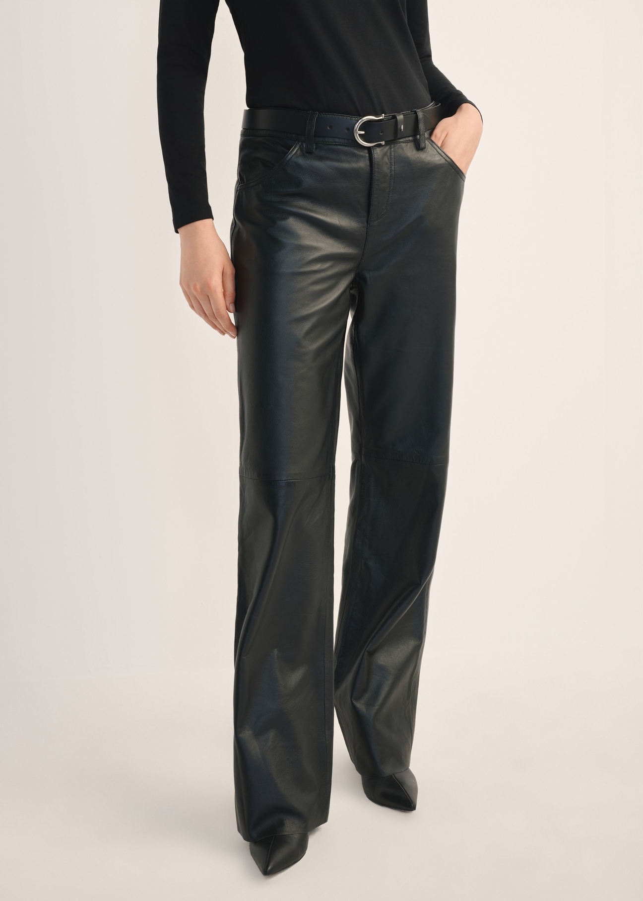 Women's black wide-leg leather trousers SPODS-0038-99(Z26), front view of the product on the model. Half of the silhouette visible.