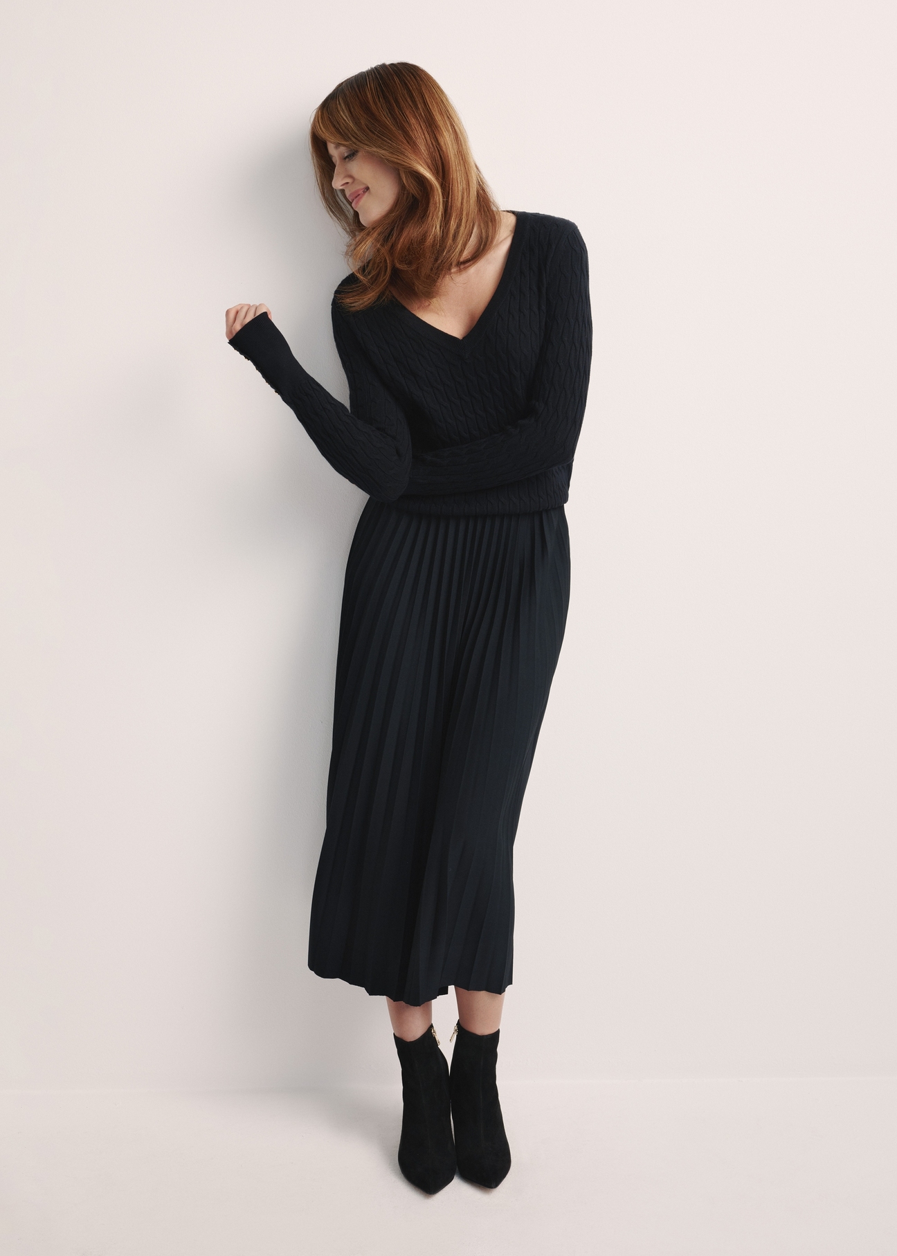 Black pleated women's dress SPCDT-0096-99(Z25), product visible from the front on the model, the entire silhouette is visible.