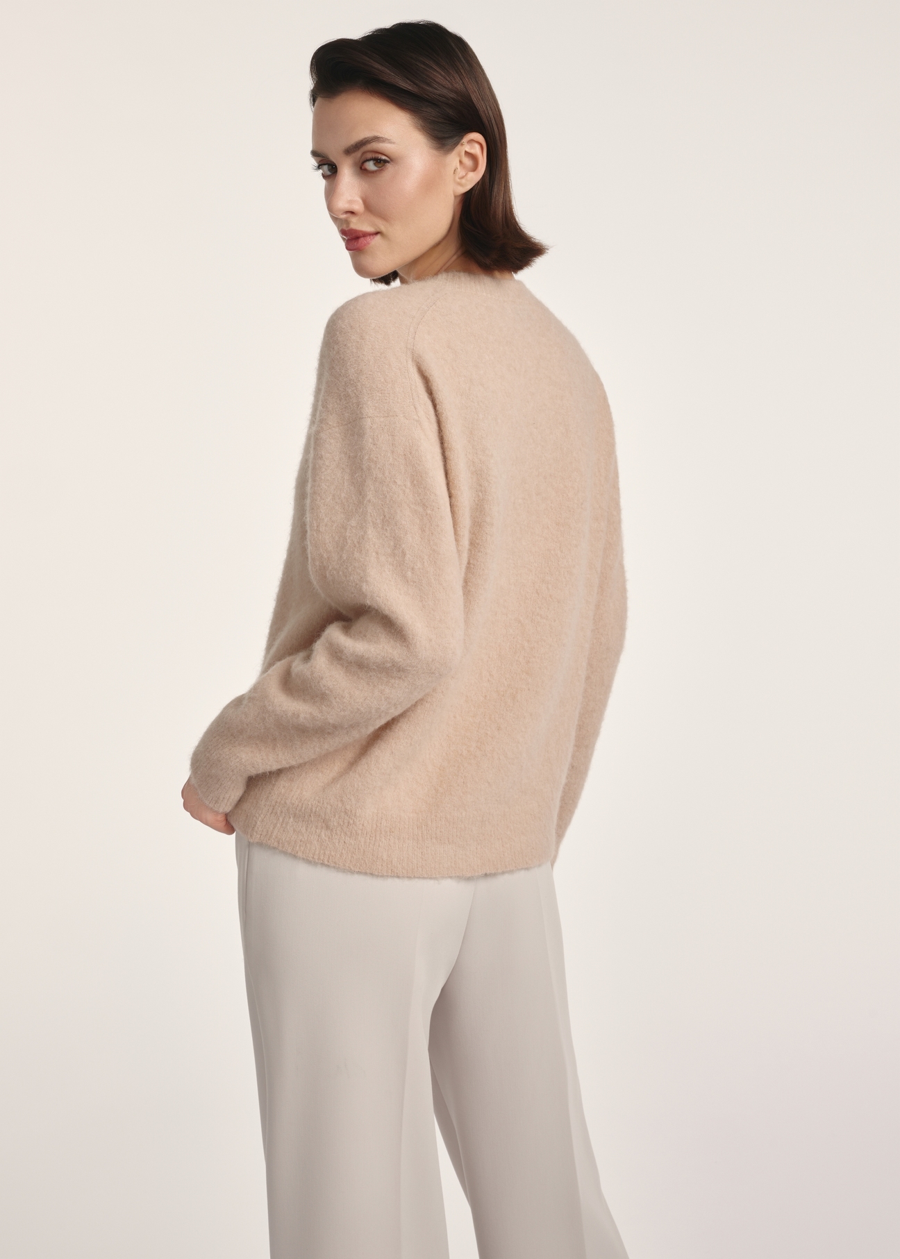 Beige woolen women's sweater SWEDT-0215-81(Z25), product view from the back on the model. Half of the silhouette visible.
