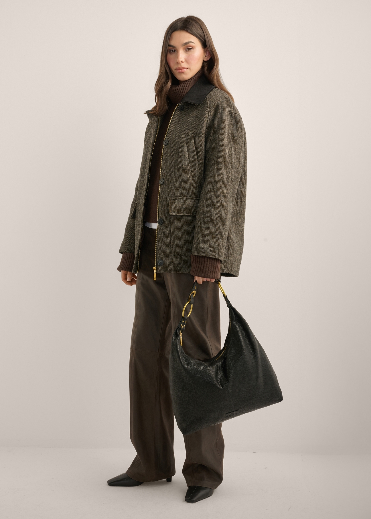 Women's leather shoulder bag TORES-1335-9I(Z26), front view of the product on a model. Full body visible.