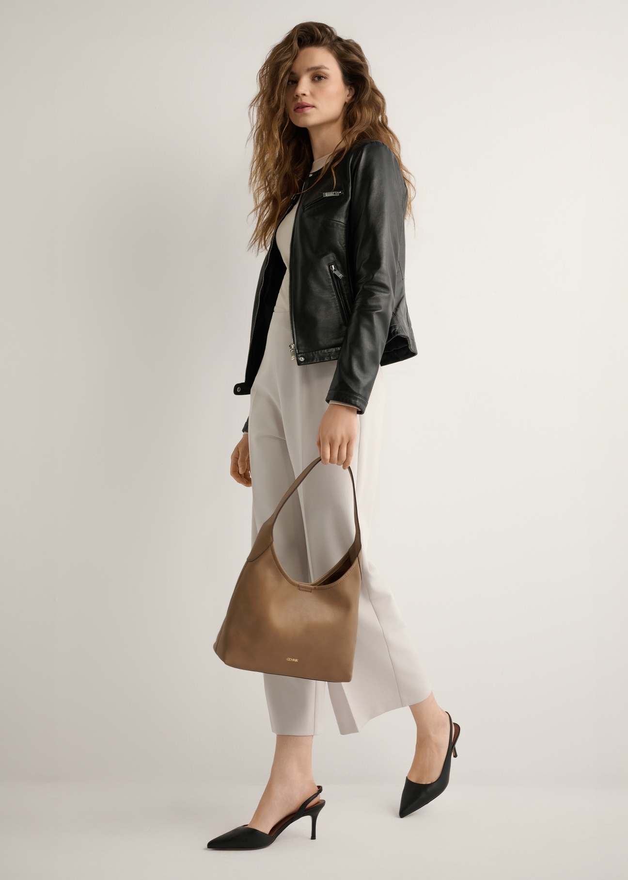 Camel medium women's handbag TOREC-1200-1D(W26), product view in model's hand. Full body visible.