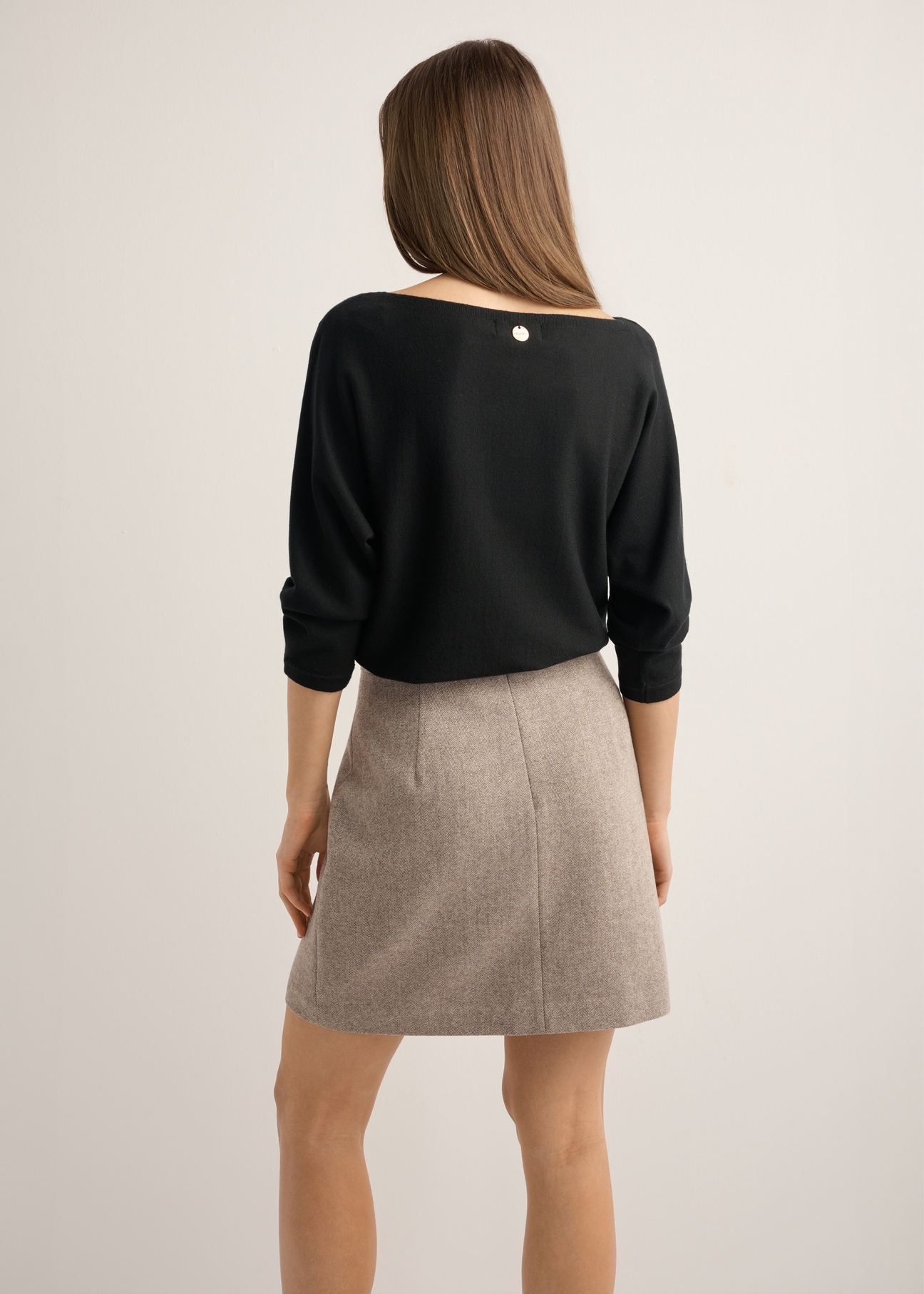 Black women's blouse BLUDT-0178-99(Z25), back view of the product on the model. Half of the silhouette visible.