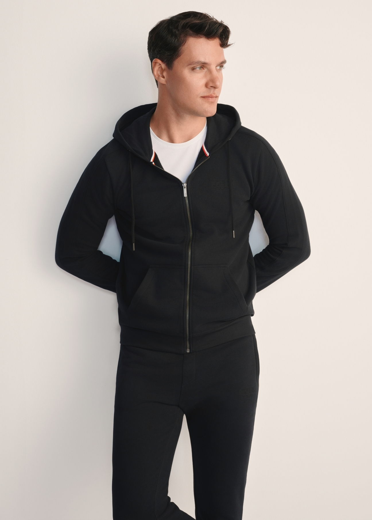 Men's black hoodie BLZMT-0074-99(Z25), front product view on model. Half of the silhouette visible.