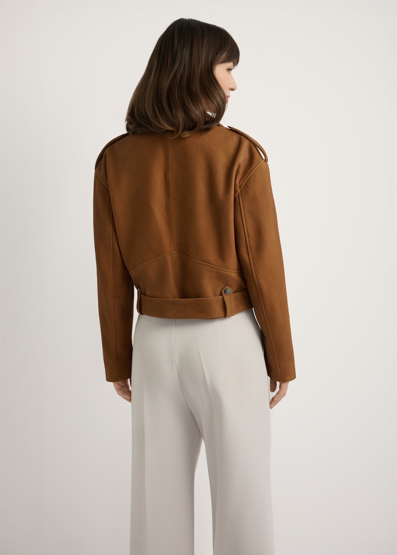 Cognac-colored leather biker jacket KURDS-0610-1F(W26), back view of the product on the model. Half of the silhouette visible.