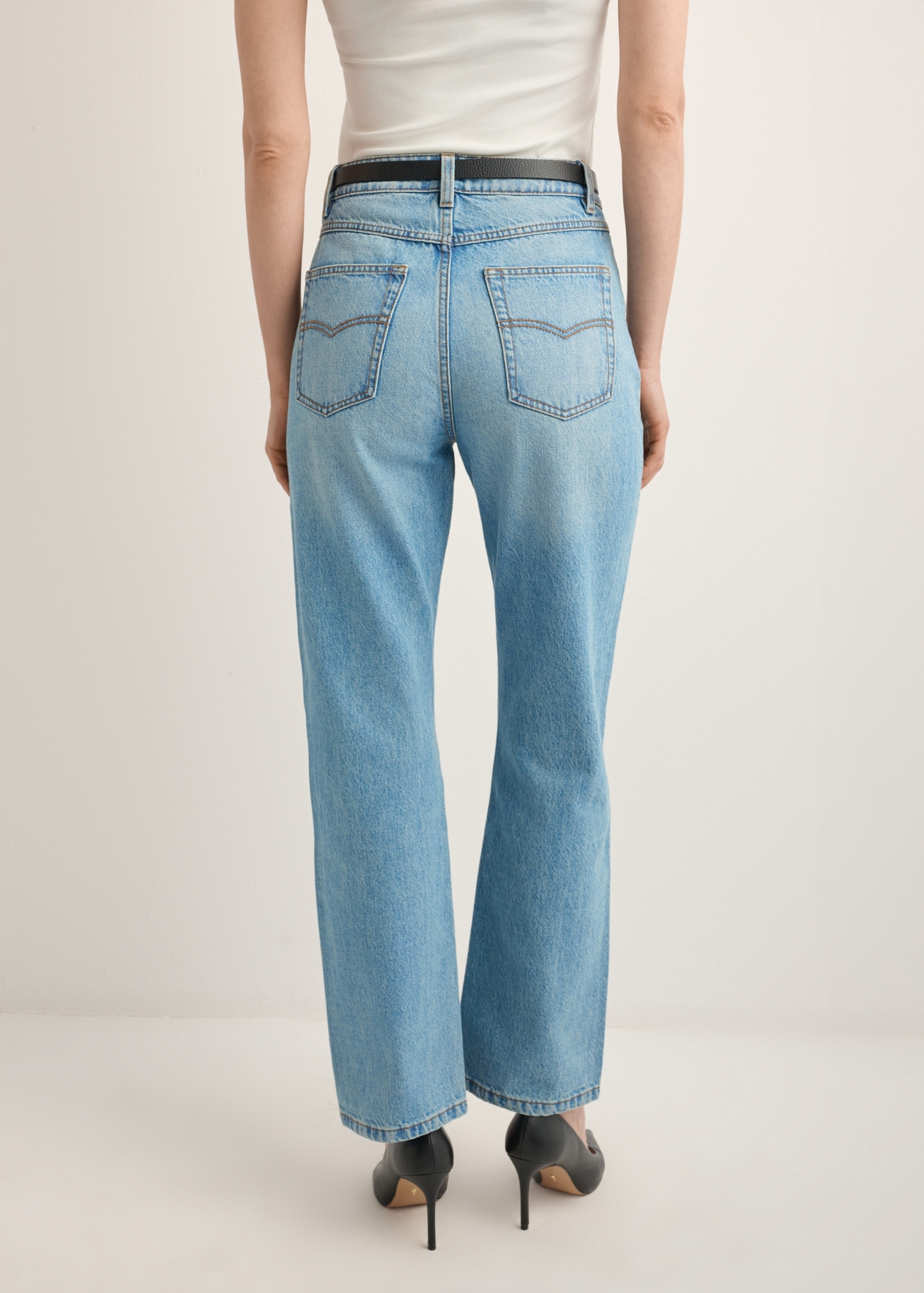 Blue women's denim pants JEADT-0016-7A(Z26), product view from the back on the model. Half of the silhouette visible.