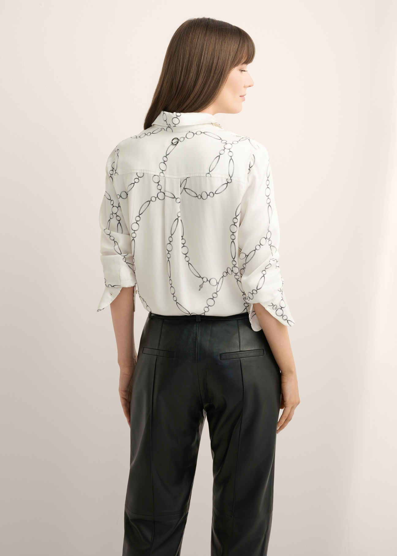 White women's shirt with print KOSDT-0172-0P(Z26), product view from the back on the model, half of the silhouette visible.
