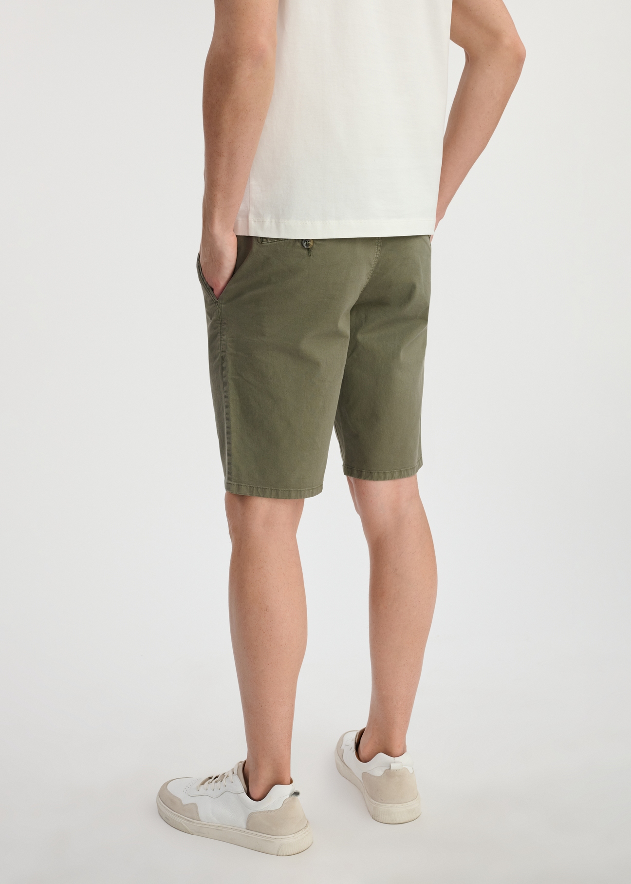 Dark green men's shorts SZOMT-0029-54(W25) - back view on the model on a white background. Half of the silhouette visible.