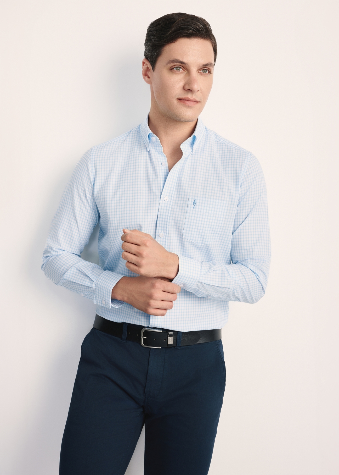 Men's cotton shirt in light blue checkered pattern KOSMT-0277-58(Z25), front view of the product on the model, half of the silhouette visible.