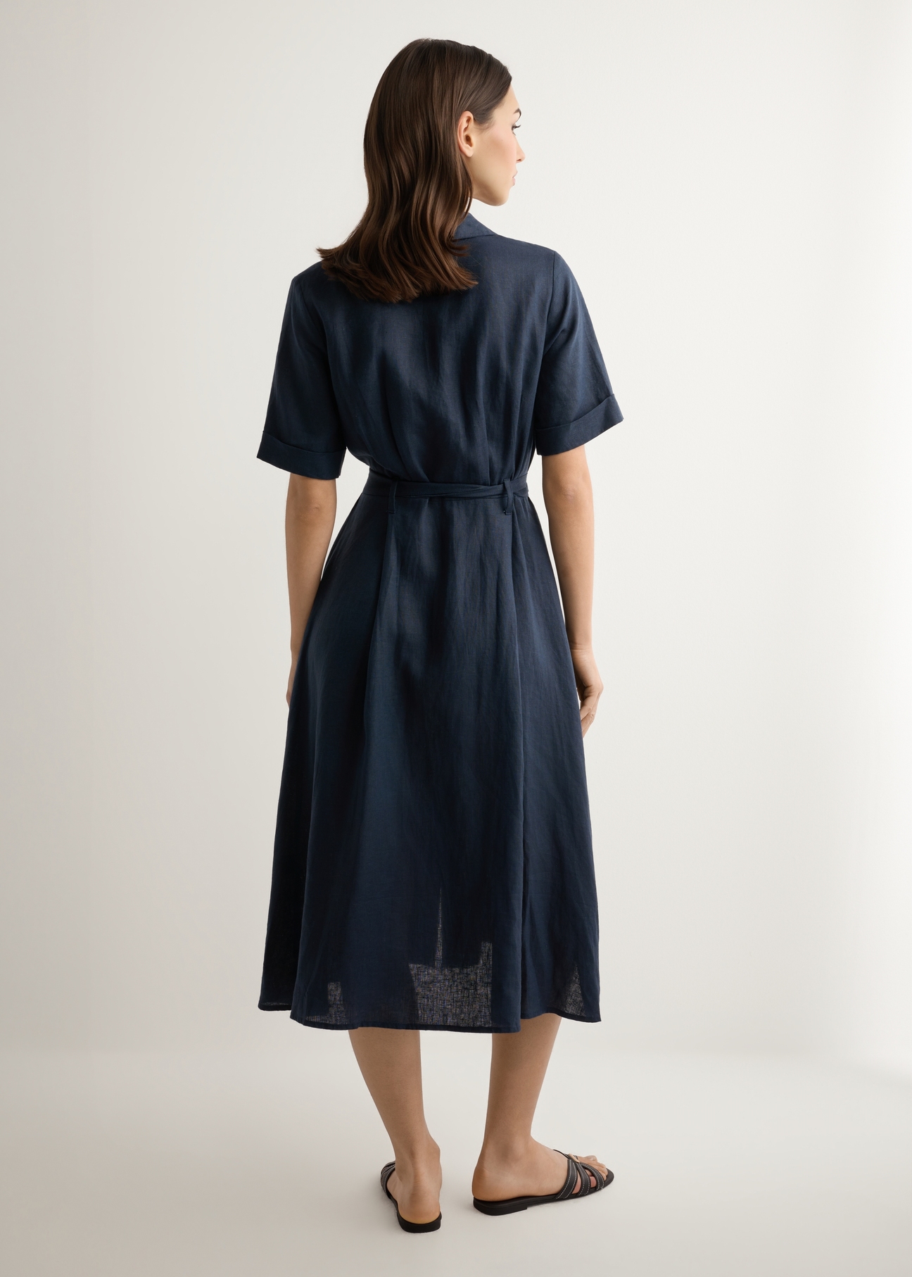 Dark navy linen midi shirt dress SUKDT-0281-7E(W26), back view of the product on the model against a light background. Full silhouette visible.