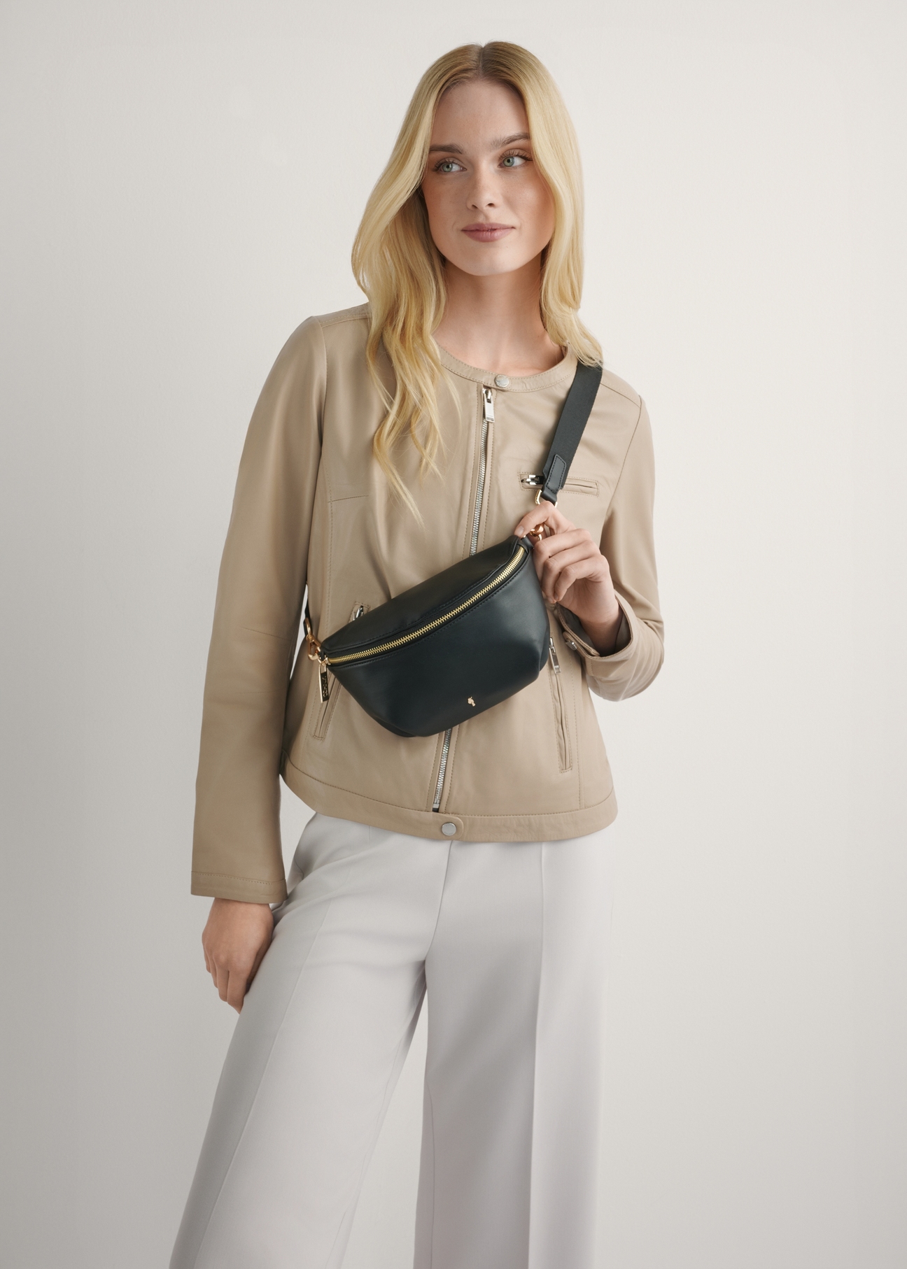 Black women's waist bag TOREC-1119-99(W26), front view of the product on the model's silhouette.