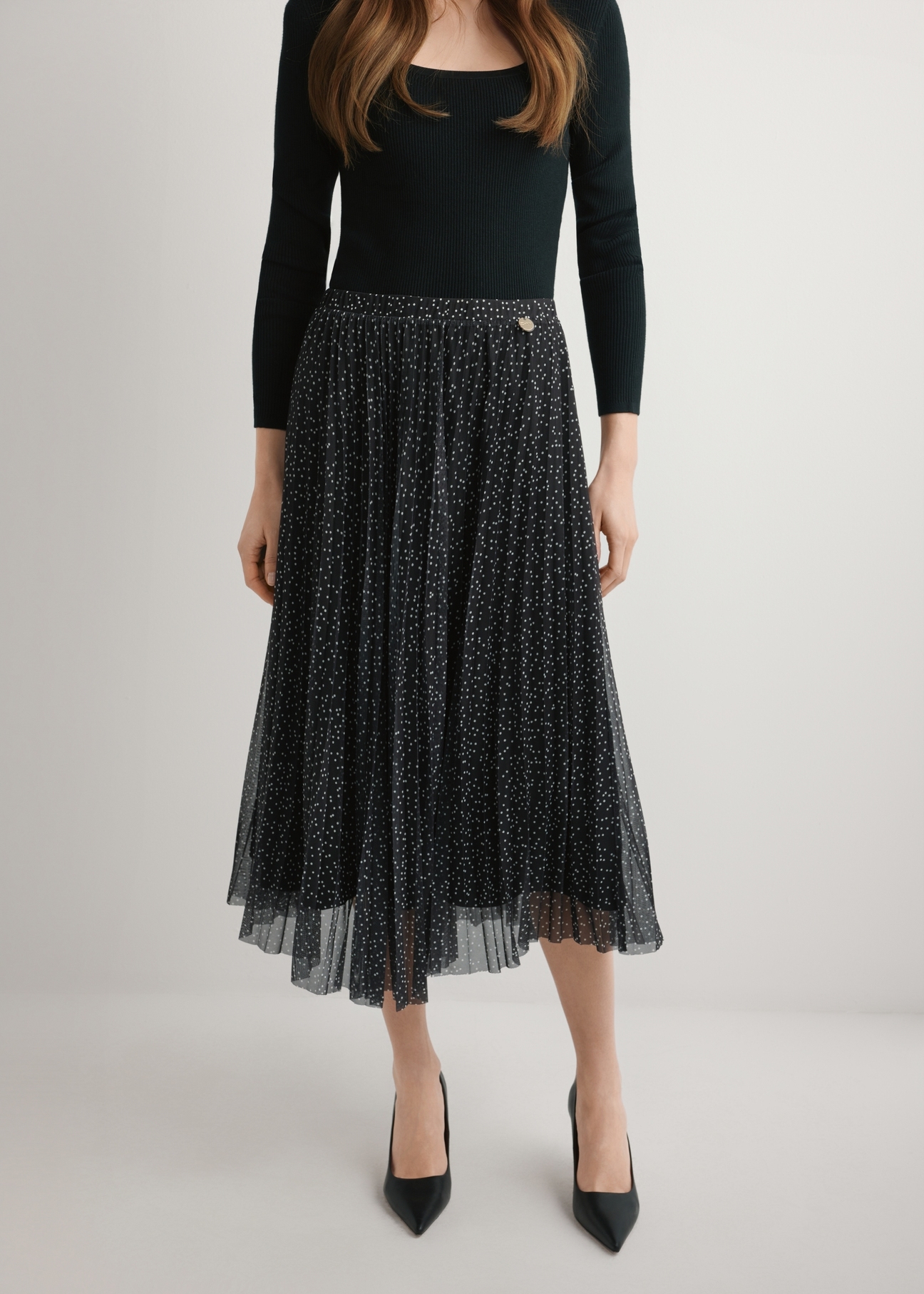 Polka dot pleated midi skirt SPCDT-0110-9P(W26), product view from the front on the model, half of the silhouette visible.