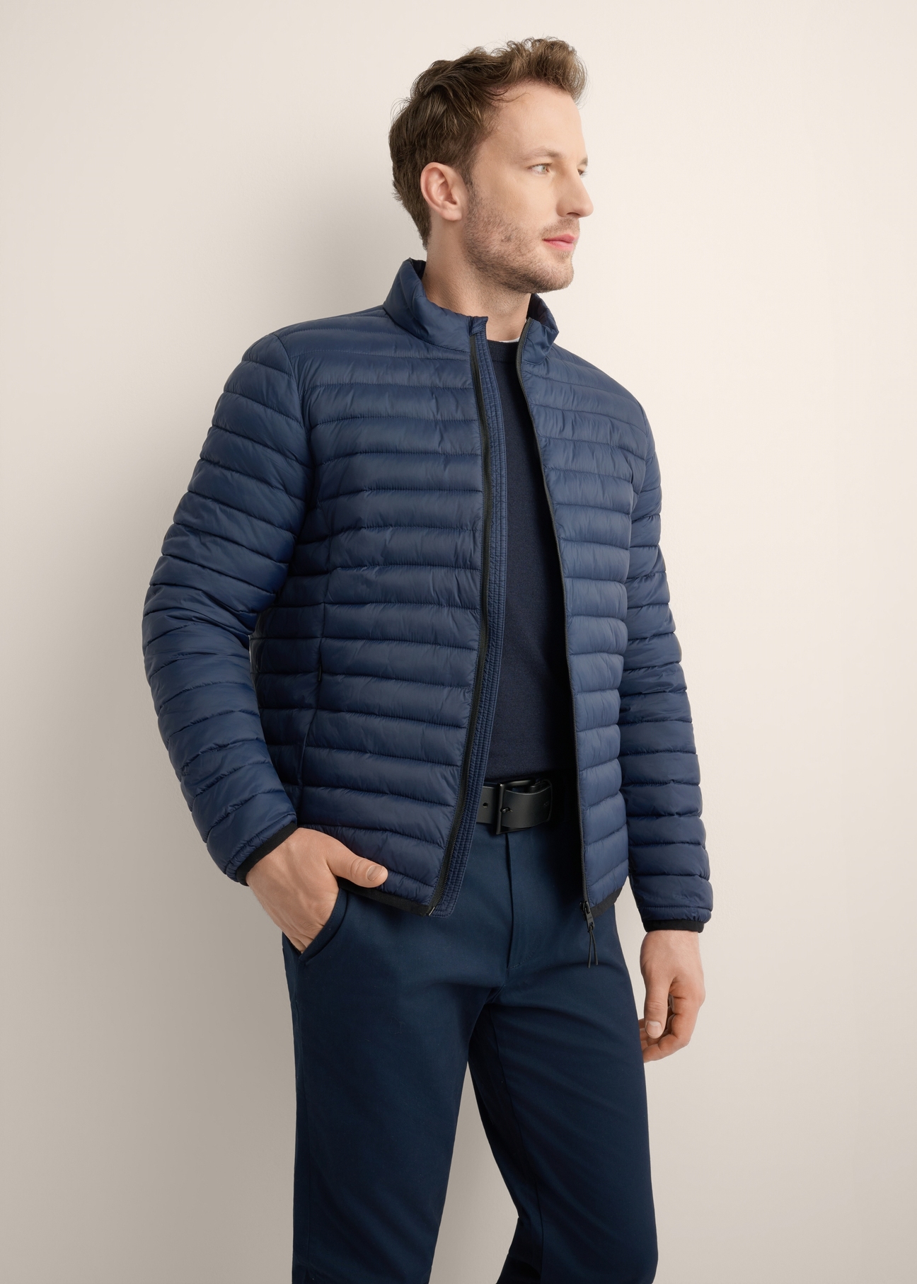 Navy blue men's transitional jacket KURMT-0382-7E(Z26), diagonal view of the product on the model, half of the silhouette visible.