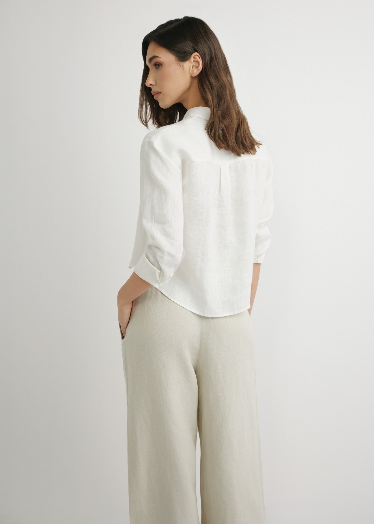 Women's white linen shirt KOSDT-0185-0B(W26), back view of the product on the model. Half of the silhouette visible.