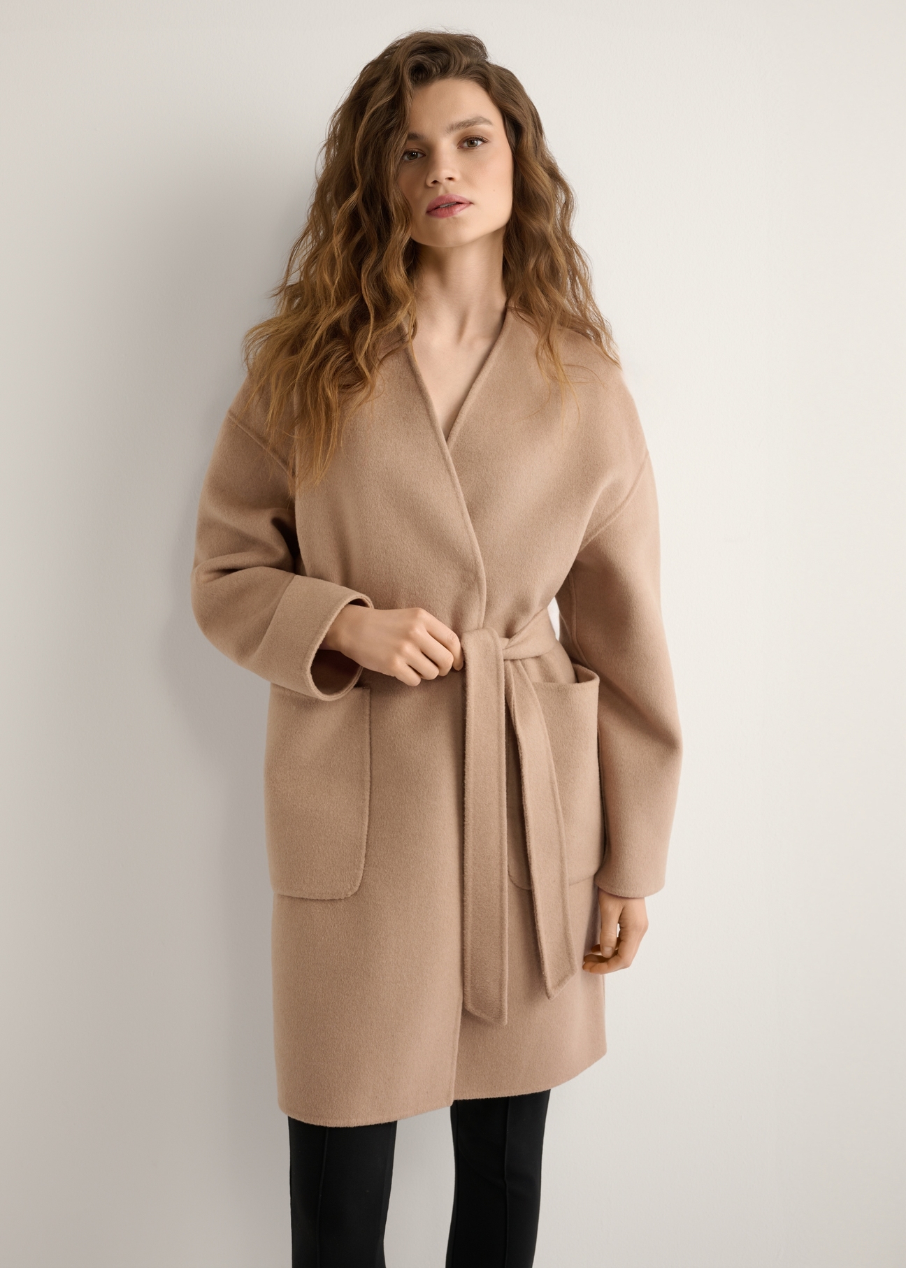 Women's dark beige wool coat PLADT-0075-1C(W26), front view of the product on the model. Half of the silhouette visible.