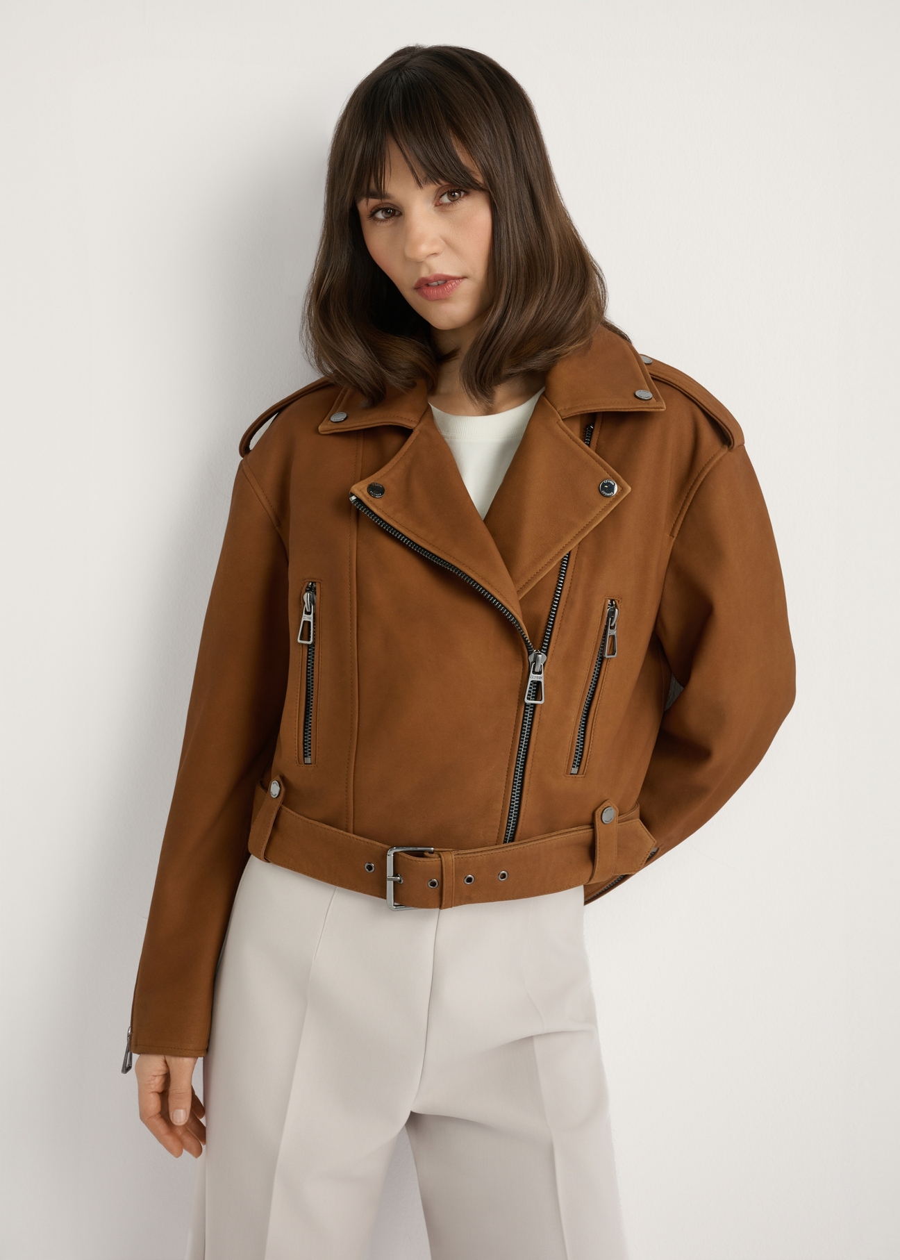 Cognac leather biker jacket KURDS-0610-1F(W26), front view of the product on the model. Half of the silhouette visible.