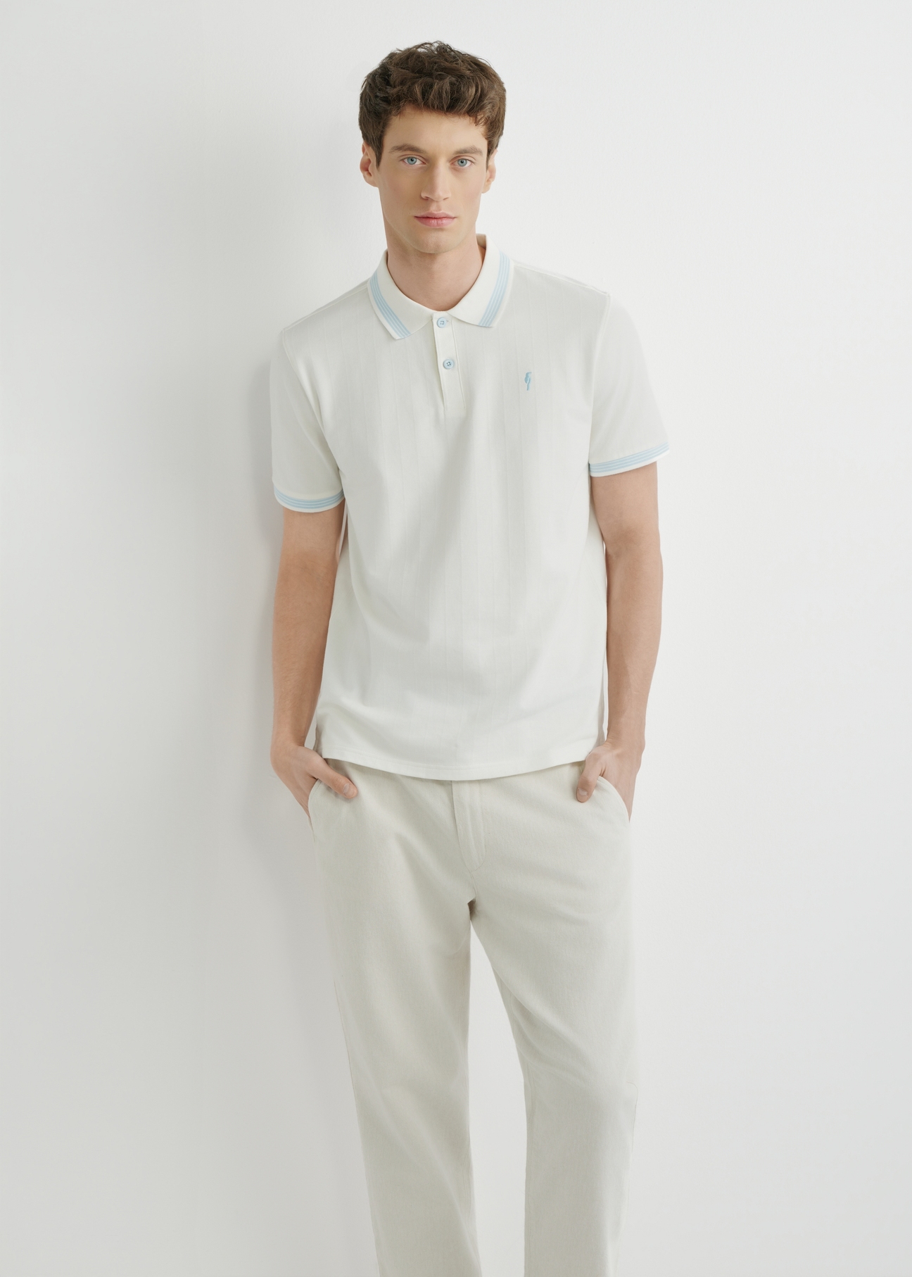 White polo shirt POLMT-0090-0B(W26), front view of the product on the model. Half of the silhouette visible.