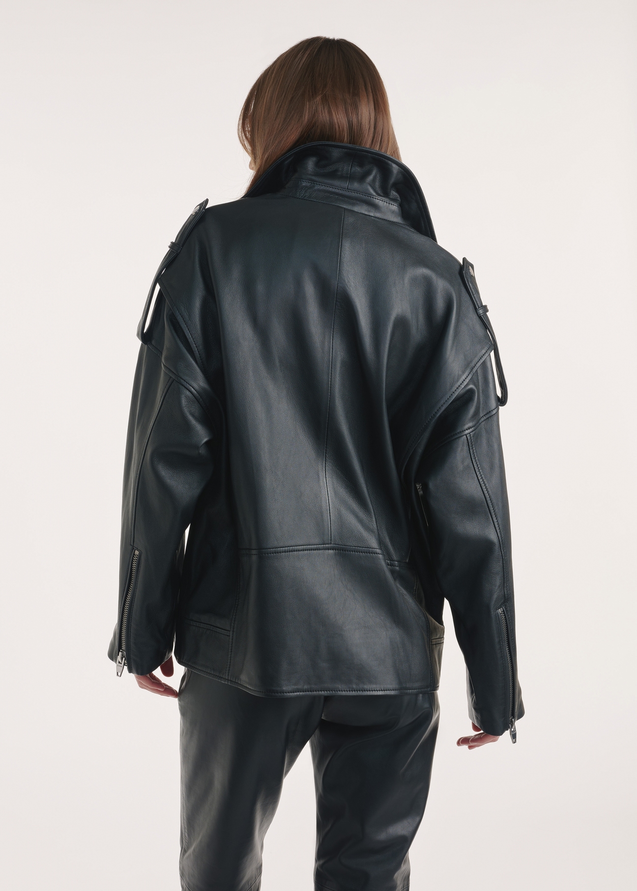 Black oversize women's leather jacket KURDS-0555-2878(Z25), product view from the back on the model, half of the silhouette visible.