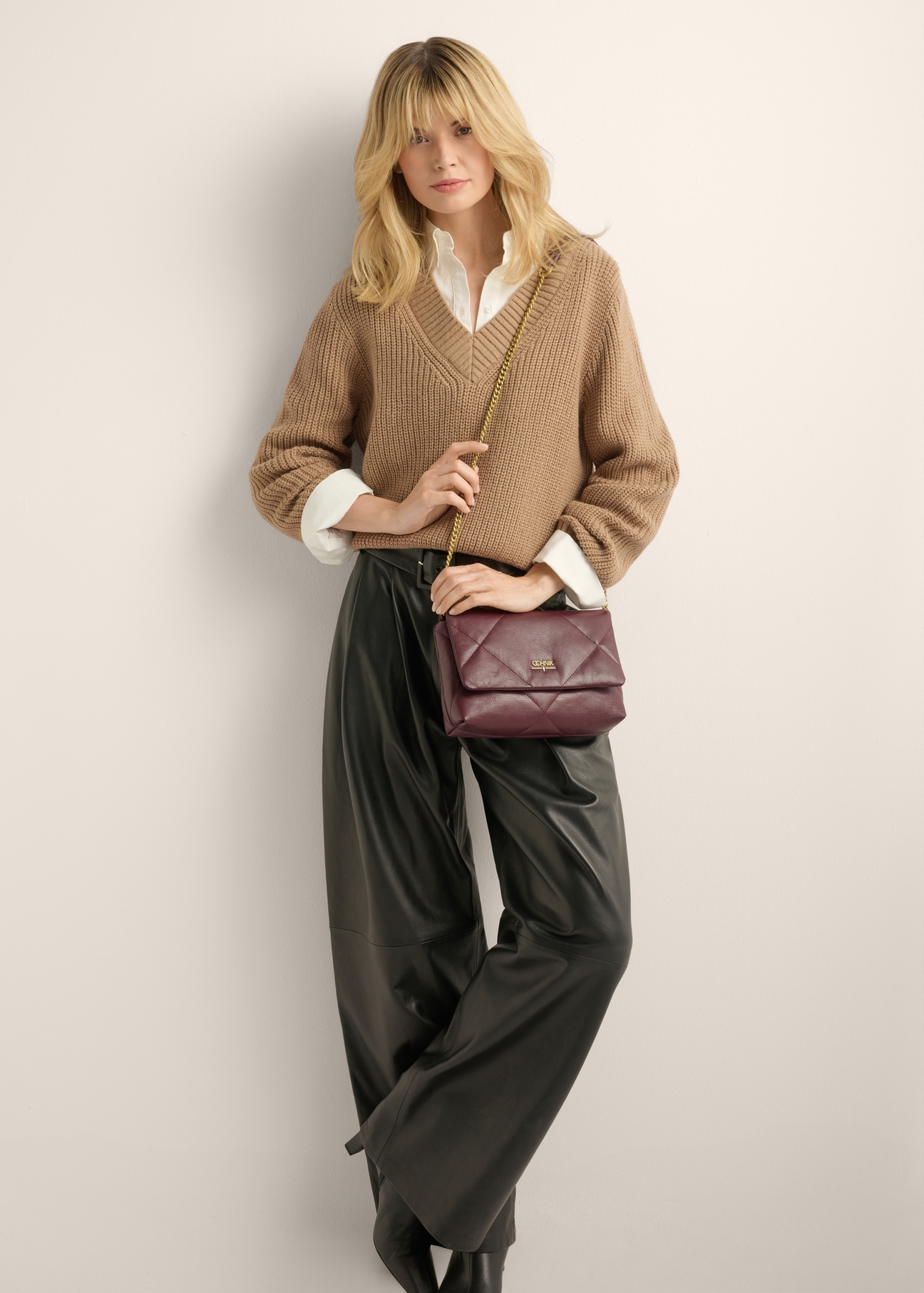 Small burgundy leather handbag TORES-1362-4D(Z26), product view on model's shoulder. Full body visible.