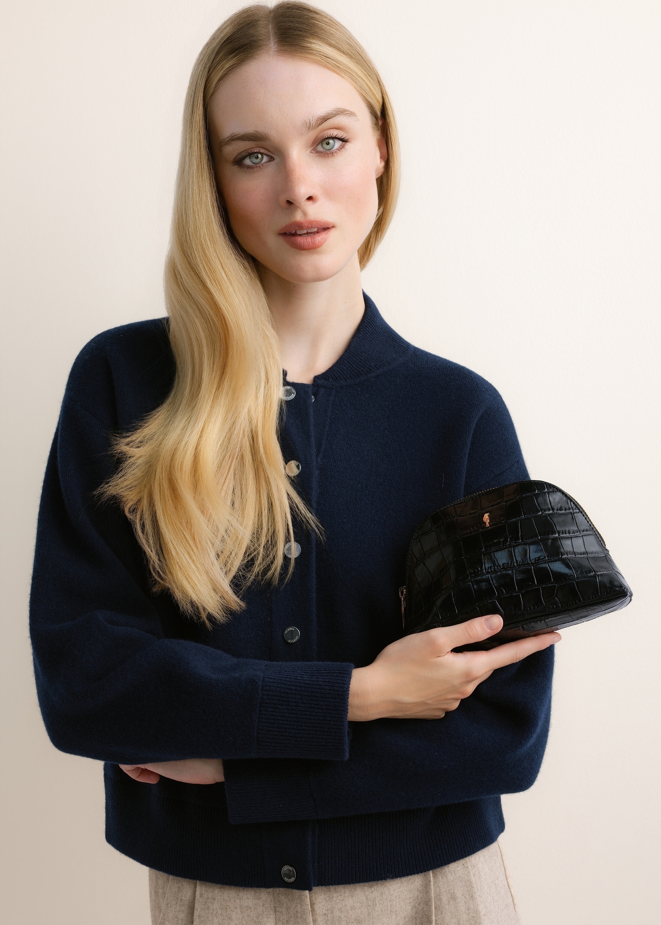 Black croc-effect toiletry bag TORES-1322-99(Z26); front view of the product held in a model's hand.