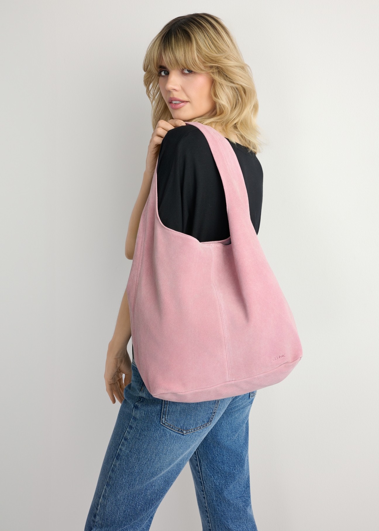 Women's pink suede shopper bag TORES-1177-5B(W26) - front view of the product, on a model, against a light background. Half of the silhouette visible.