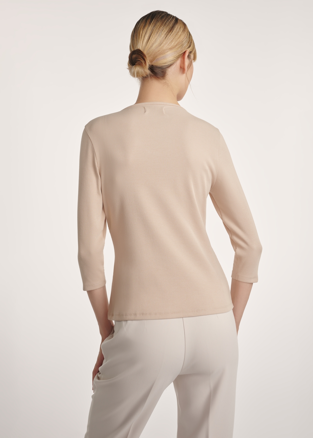 Beige women's V-neck blouse LSLDT-0036-80(Z24), product view from the back on the model, half of the silhouette visible.