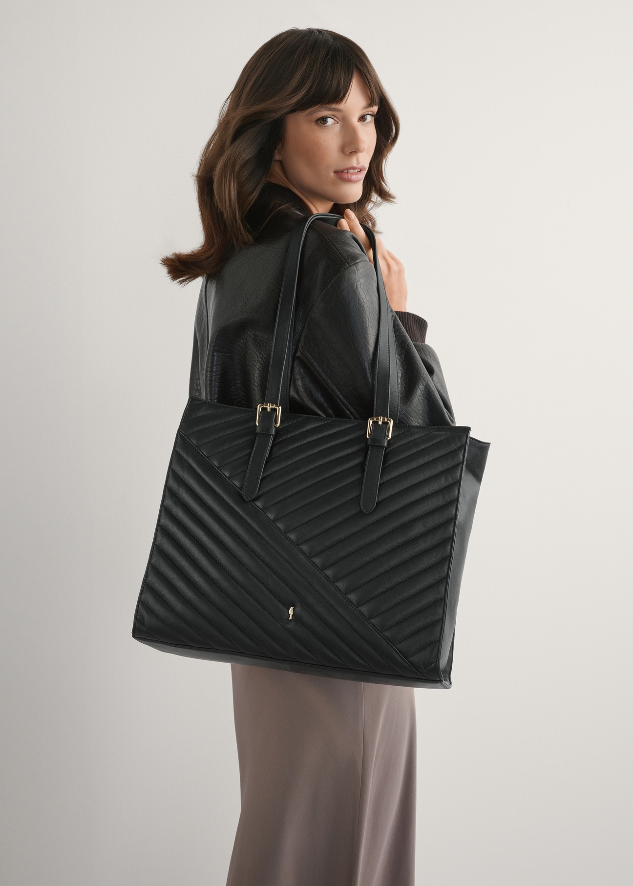 Large black leather women's handbag TORES-1287-99(W26), front view of the product on a model, half of the silhouette visible.