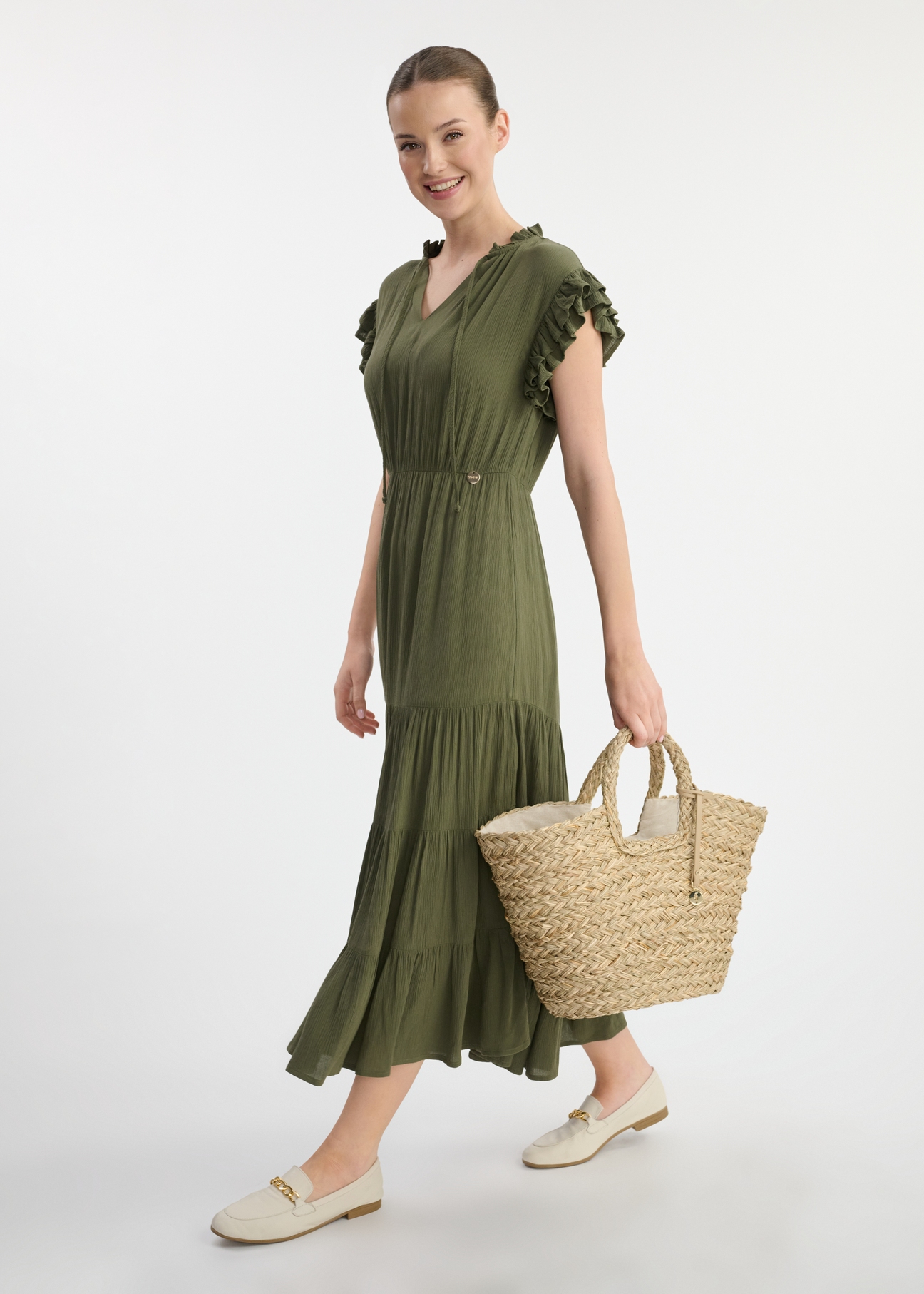Large women's straw handbag TOREC-1041-25(W25), front view of the product on the model. The whole silhouette is visible.