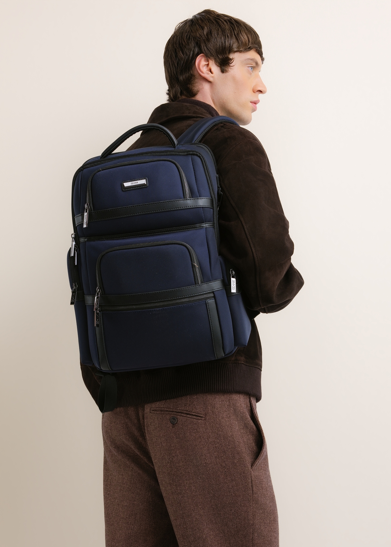 Navy blue men's backpack TORMN-0439-7D(Z26), front view of the product on the model. Half of the silhouette visible.