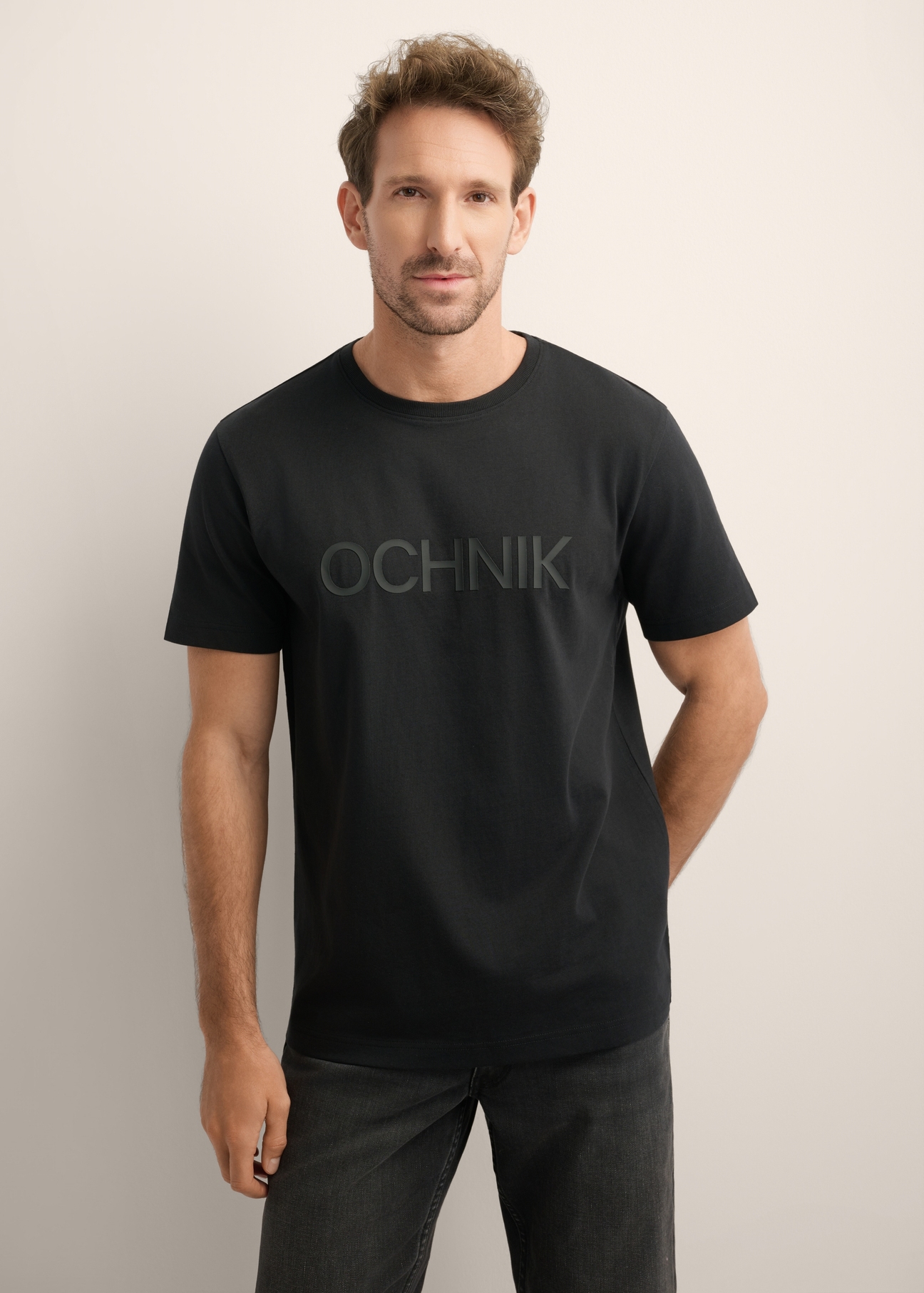 Men's black cotton T-shirt TSHMT-0154-99(Z26), front view of the product on the model. Half of the silhouette visible.