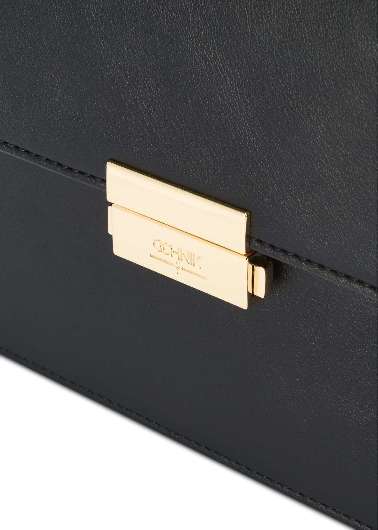 Black women's handbag TOREC-1080-99(Z25), close-up of the product buckle, view on a white background.