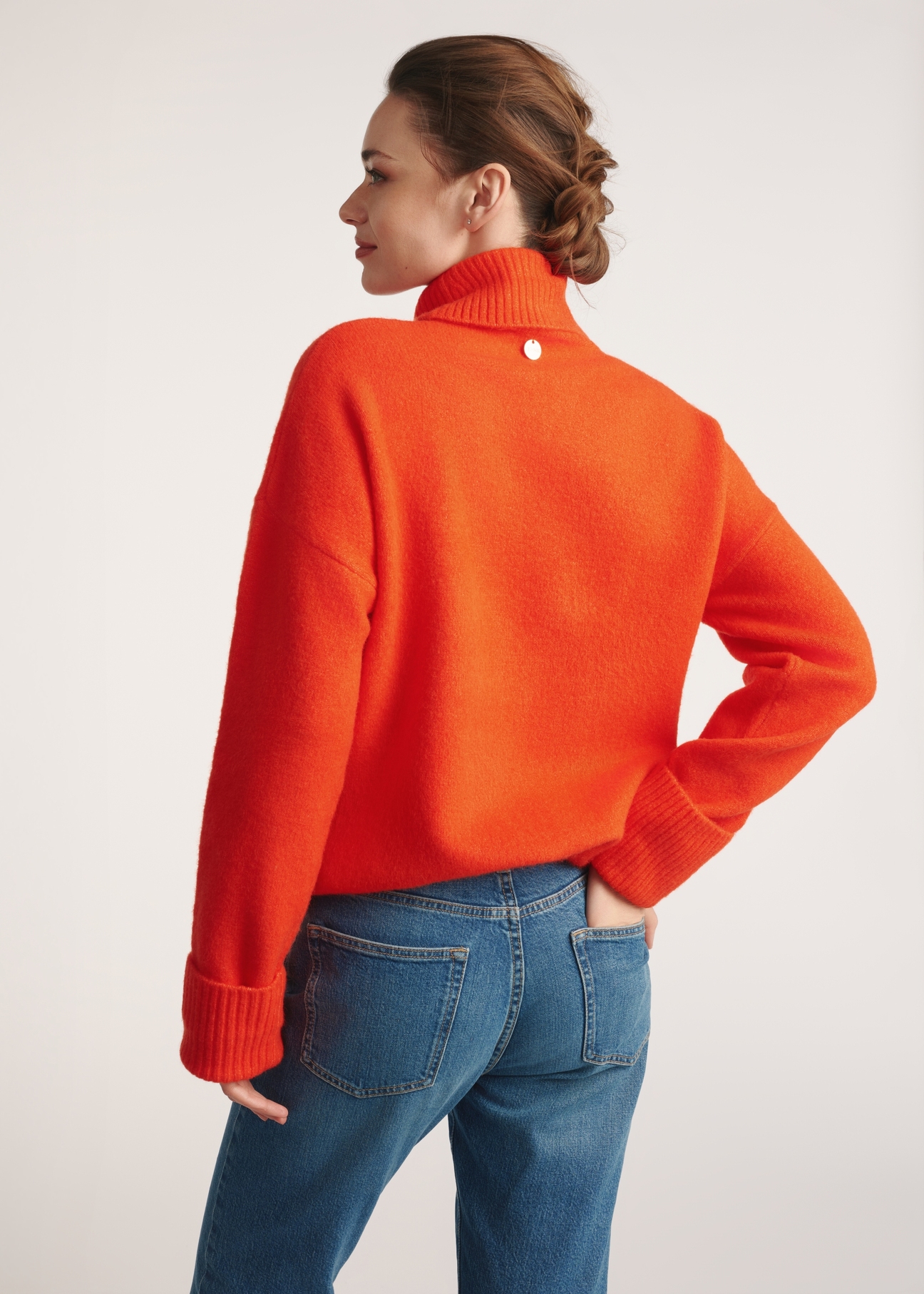 Orange women's turtleneck SWEDT-0249-30(Z25), product view from the back on the model. Half of the silhouette visible.