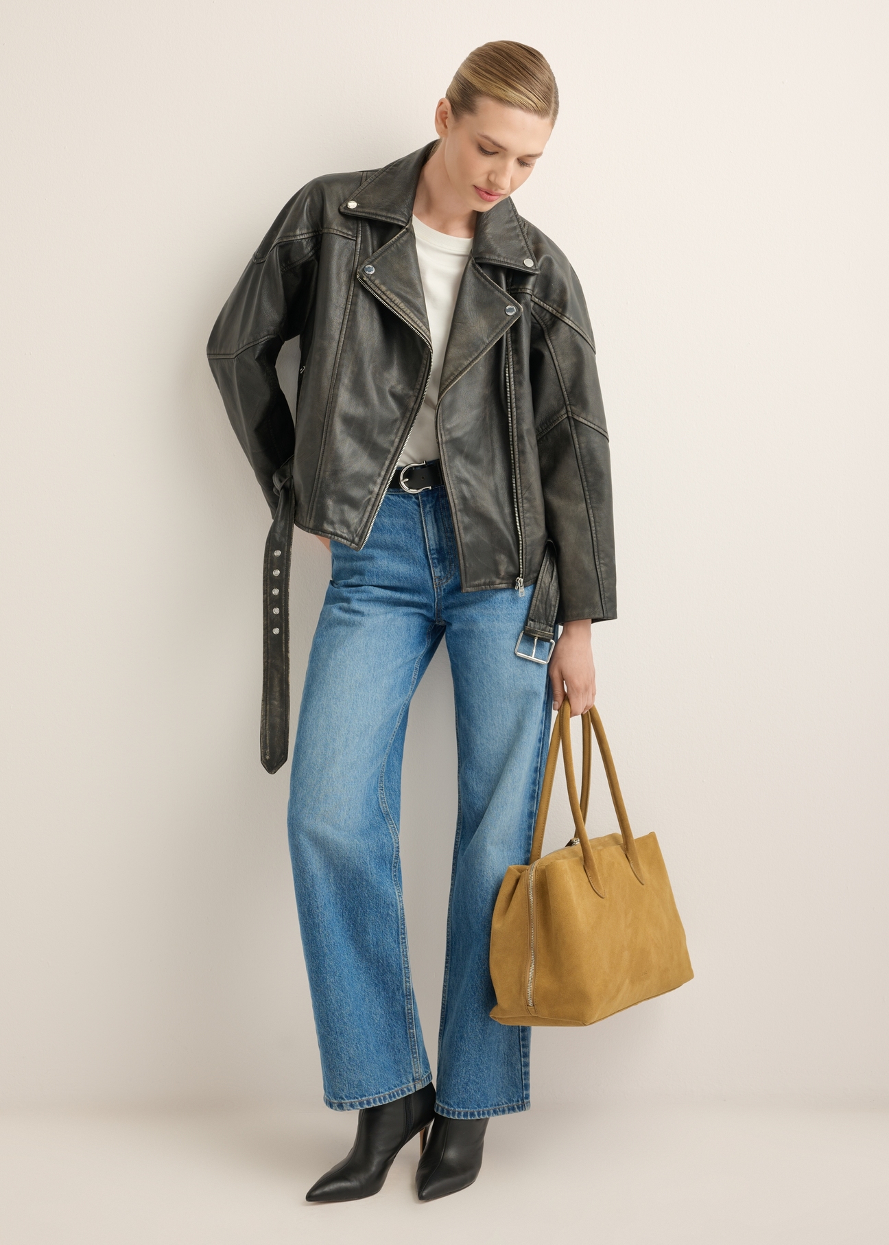 Large women's suede handbag TORES-1310-1B(W26), product view in model's hand. Full body visible.