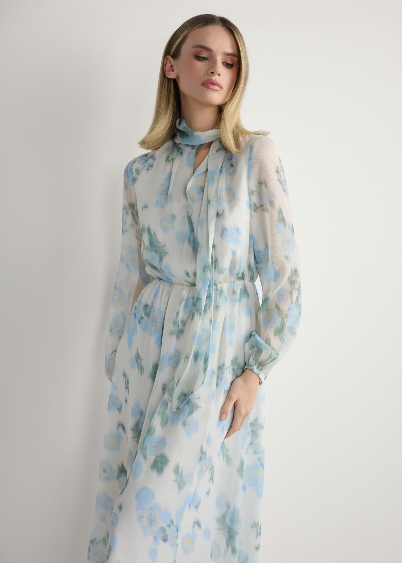 Women's cream floral dress SUKDT-0265-7P(W26), front view of the product on the model. Half of the silhouette visible.