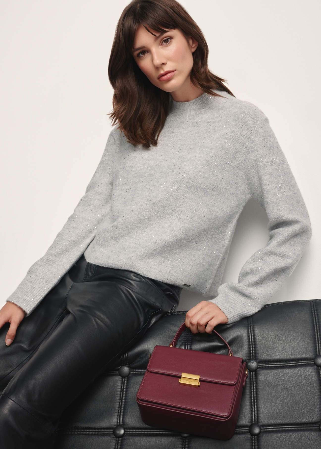 Burgundy women's trunk bag TOREC-1080-49(Z25), front view of the product on a model, half of the silhouette visible.